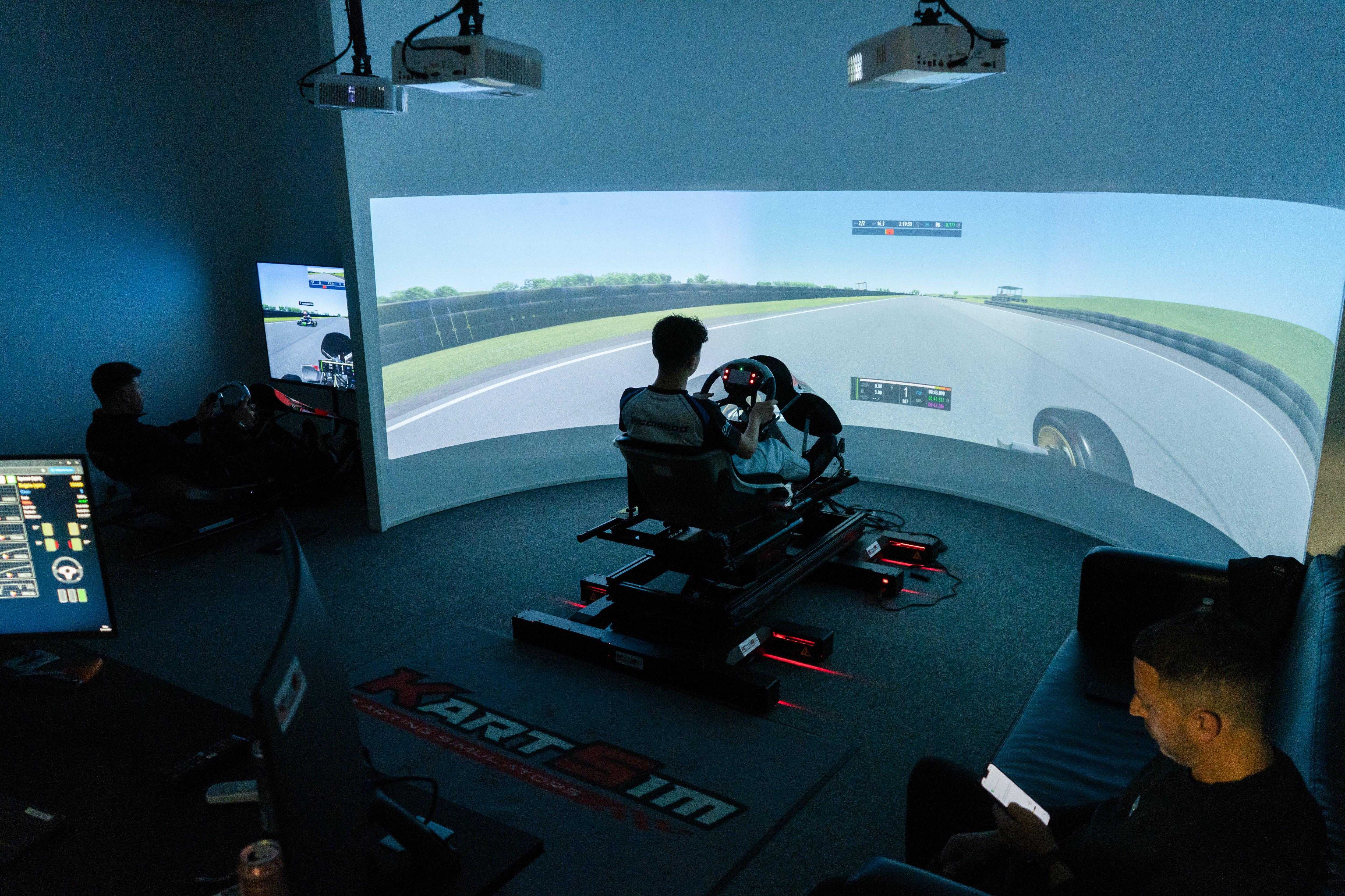 Kart driver training in professional kart simulator with motion platform and curved screen for realistic racing experience