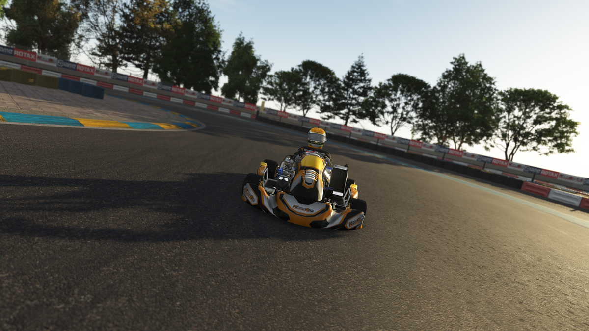 Driver using a KartSim Pro simulator with a direct drive force feedback wheel, laser-scanned circuits, and telemetry analysis for realistic kart driver training.
