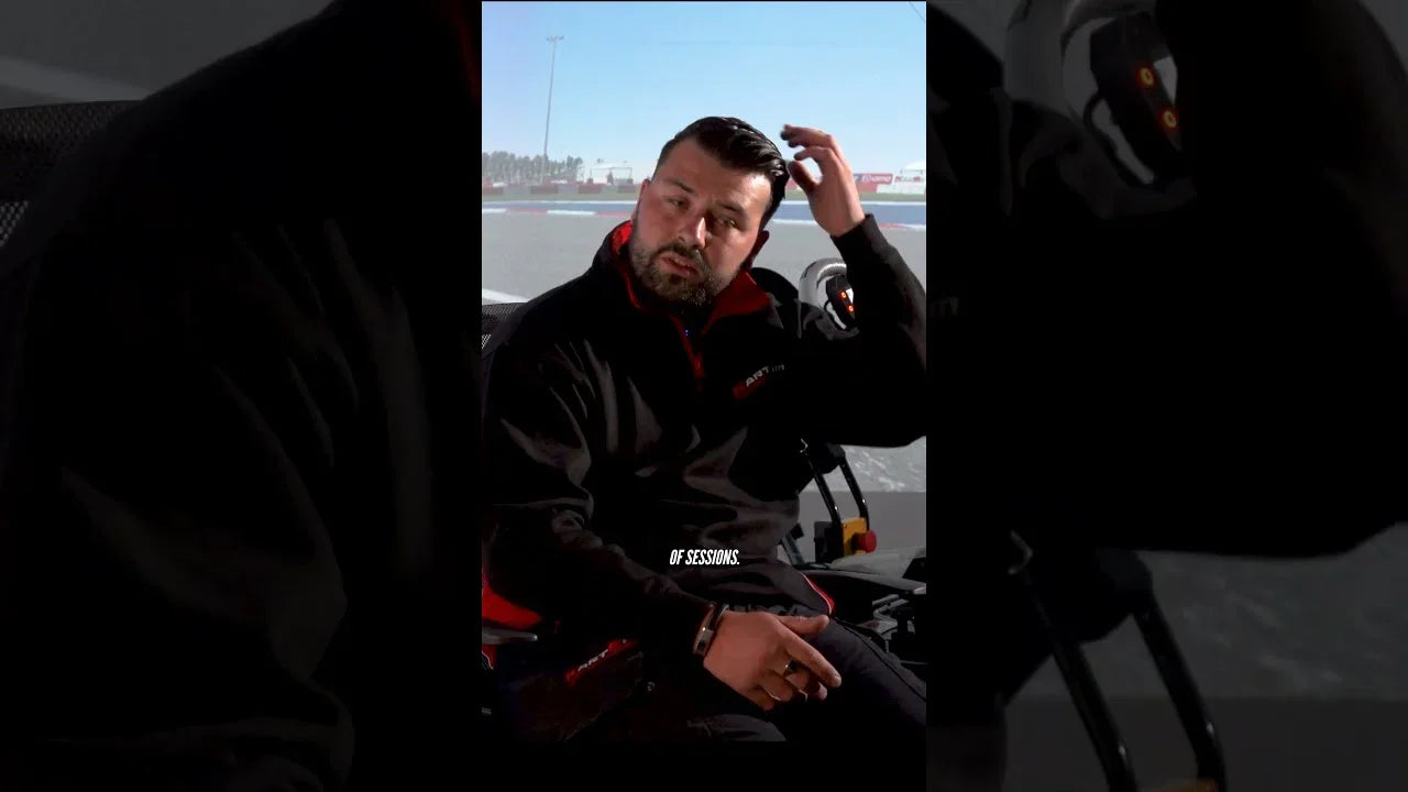 Professional driver in kart simulator cockpit reviewing kart driver training session in realistic racing environment