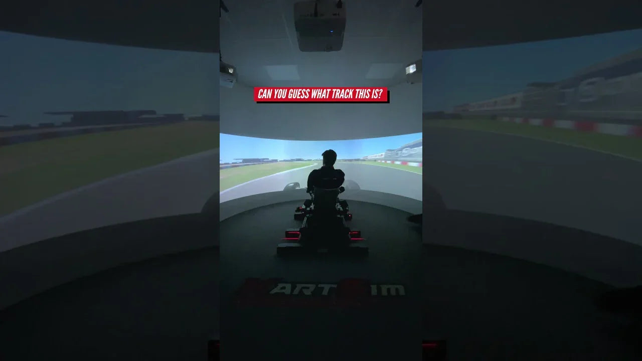 Driver using professional kart simulator rig with realistic track projection for karting training