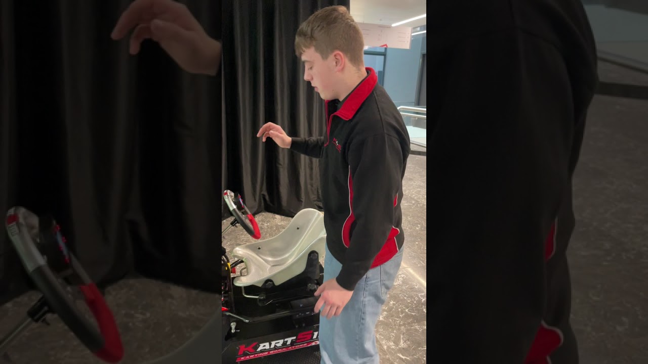 Driver testing the KartSim Pro Motion system on a realistic kart simulator for professional karting training and driver coaching.