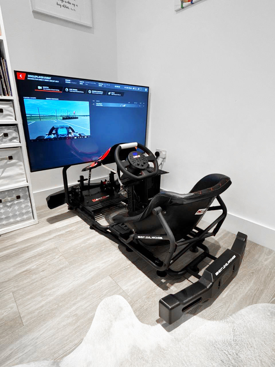 KartSim Esports Simulator – complete home setup with racing seat, direct drive steering wheel, pedals, and display running KartSim Pro Software for online racing