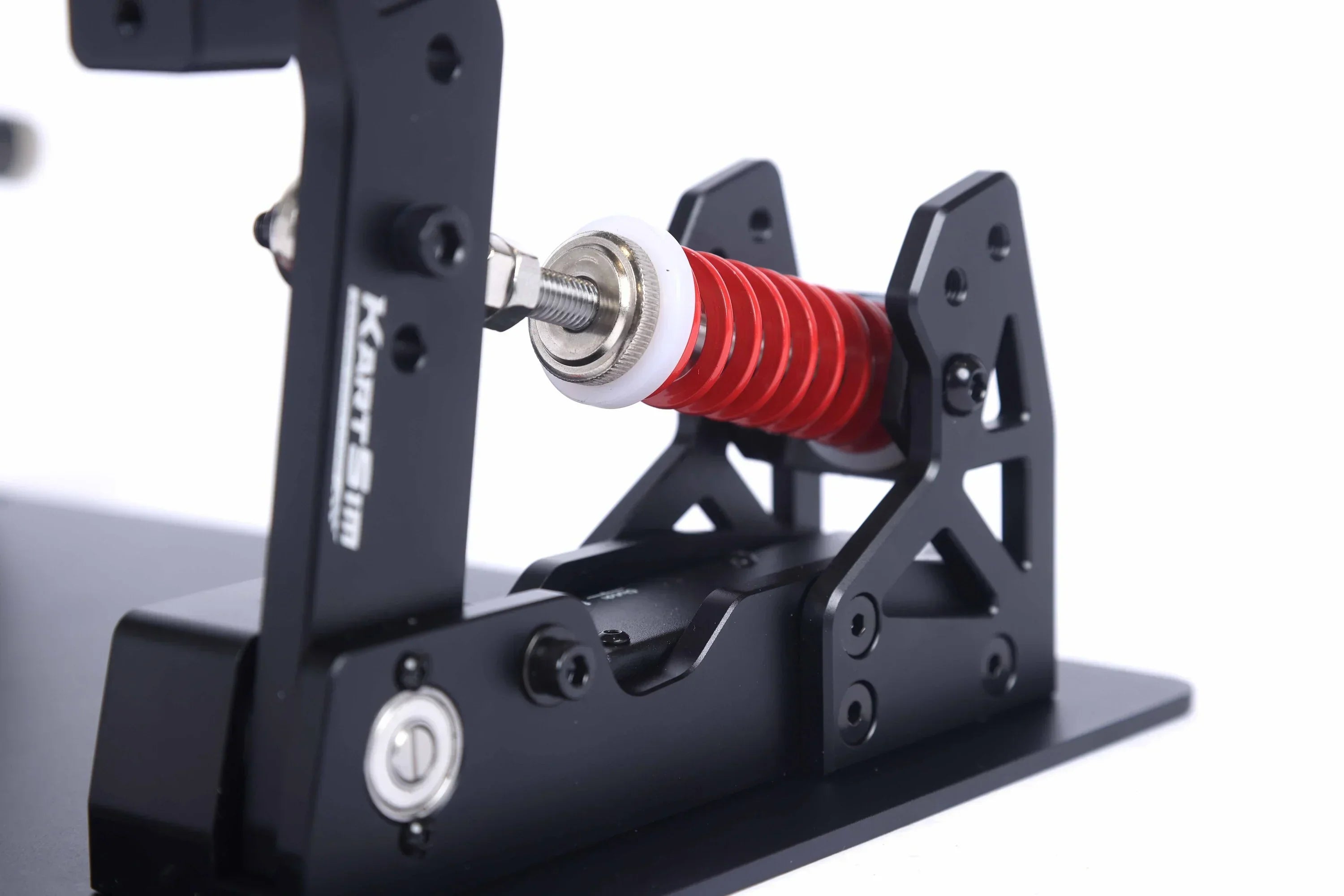 Close-up view of the KartSim eSports sim pedal brake mechanism, highlighting the red progressive spring and durable black aluminum components for precision feedback.