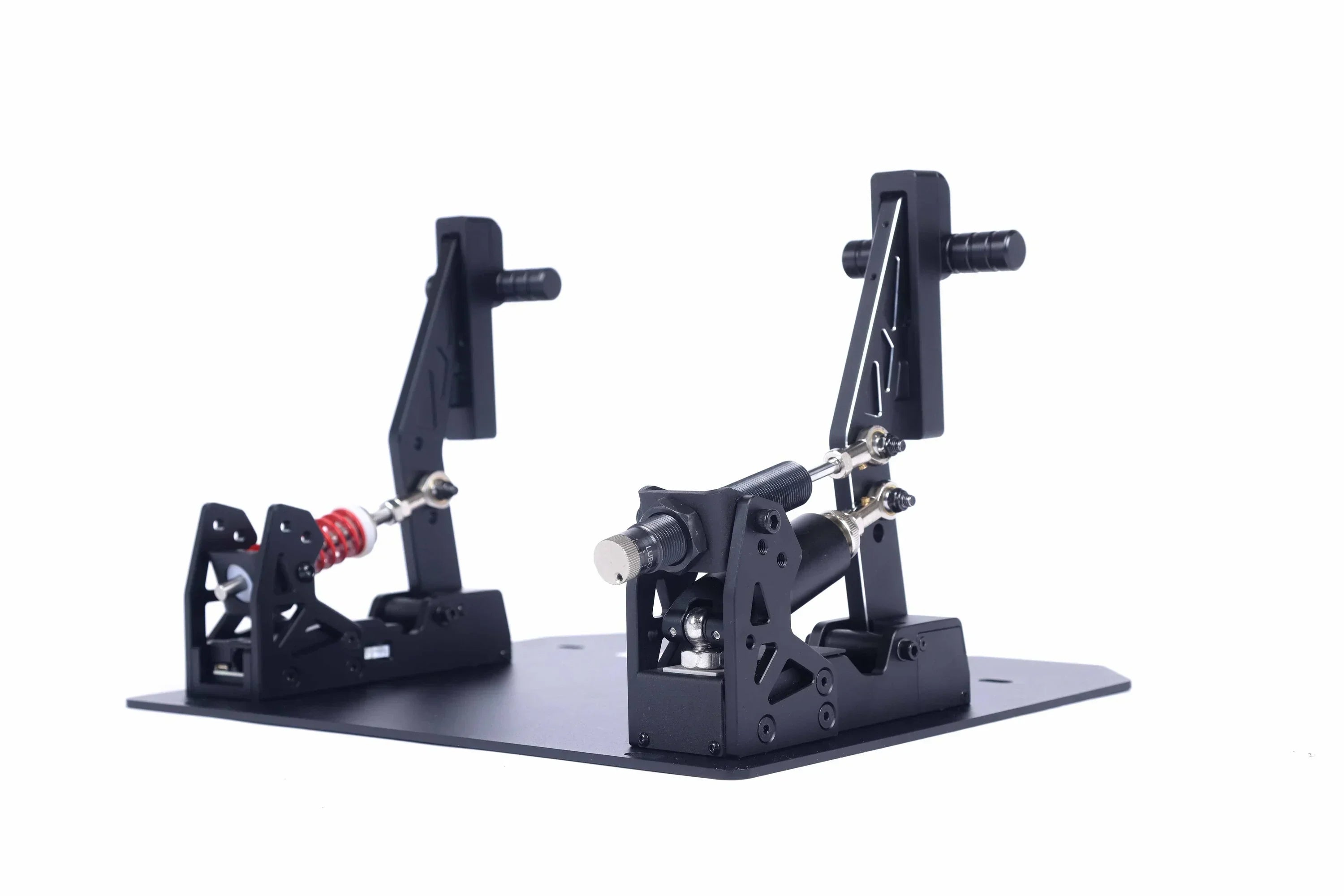 Angled view of KartSim eSports sim racing pedals featuring adjustable load cell mechanisms, durable black aluminum construction, and red progressive spring for braking realism.