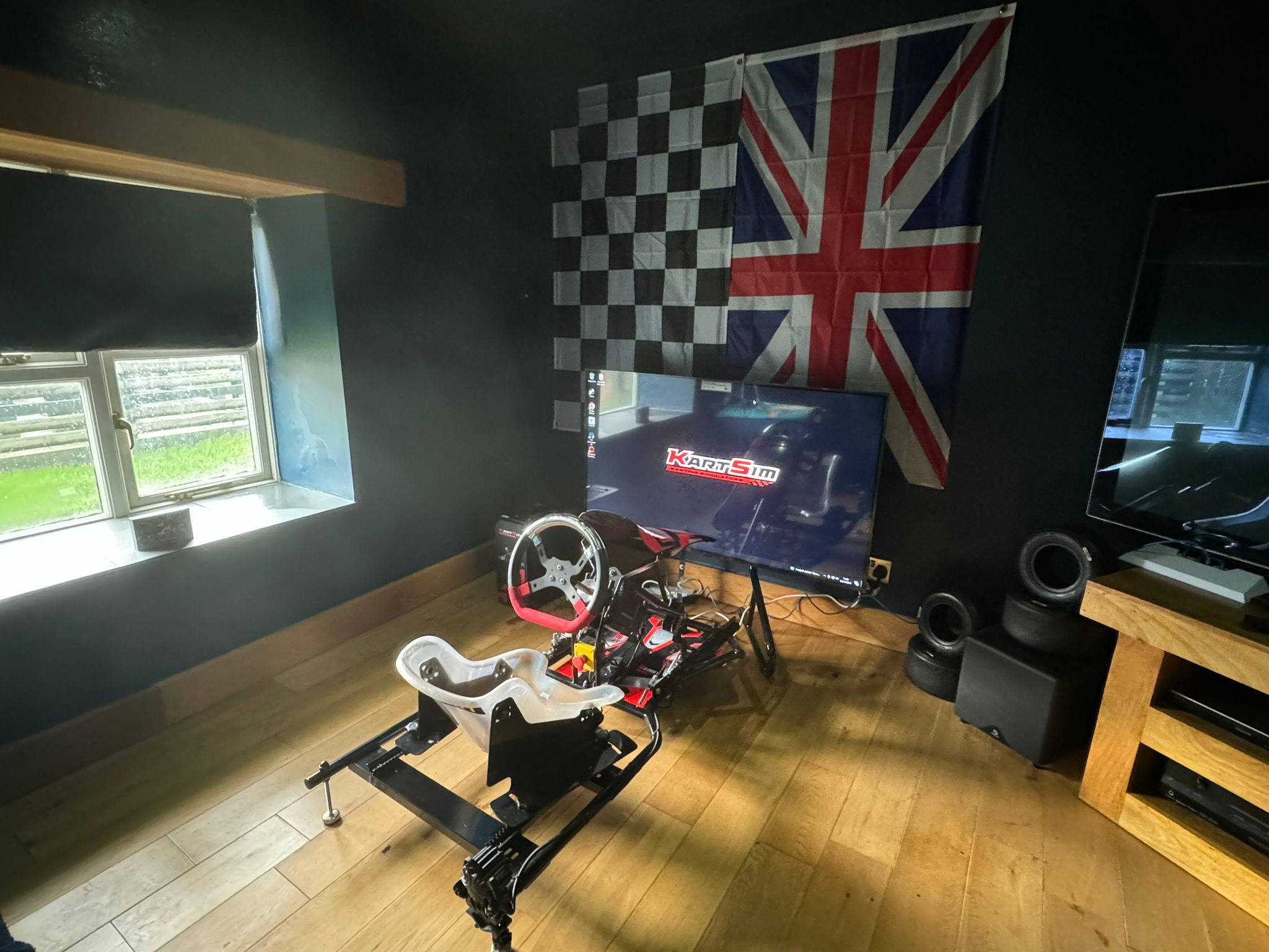 KartSim Pro Simulator placed in a dedicated race-themed room with flags and race décor, ideal for focused driver development.