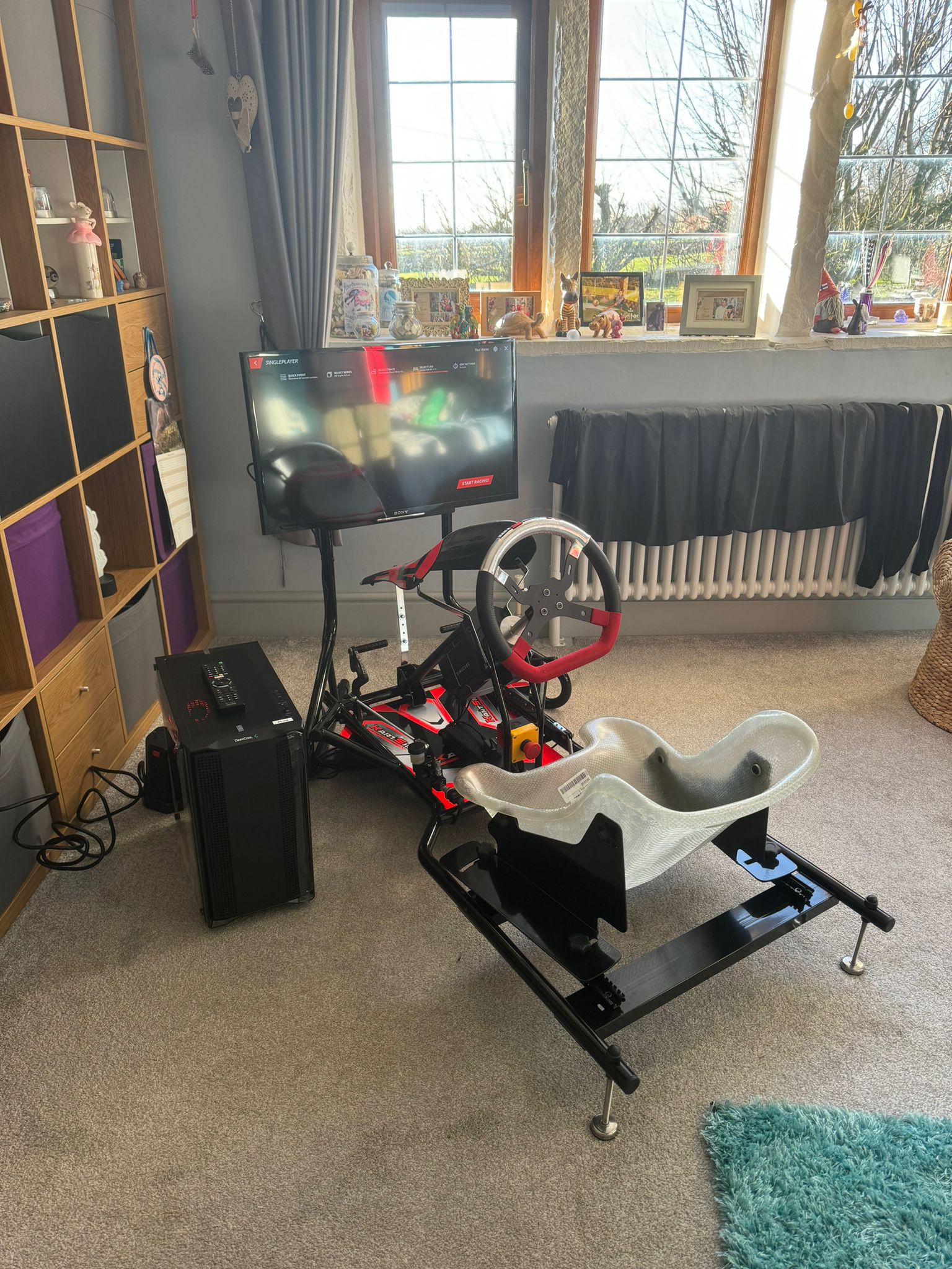 KartSim Pro Simulator positioned in a dedicated home sim space with a side window and clean racing layout.