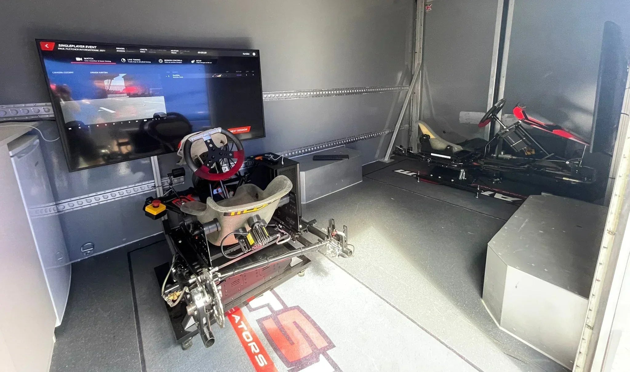 Professional kart racing simulator with realistic seating, pedals, and steering wheel for driver training