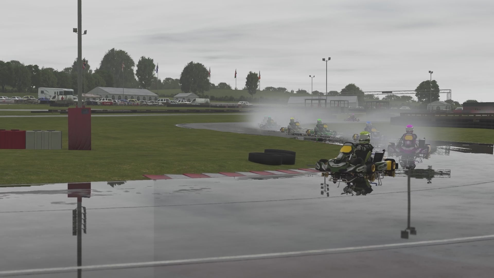 Load video: KartSim UK software showcase — gameplay montage on British kart circuits with onboard and trackside views, realistic physics and timing HUD/menus, demonstrating professional-grade simulation used as a training tool for kart racers.