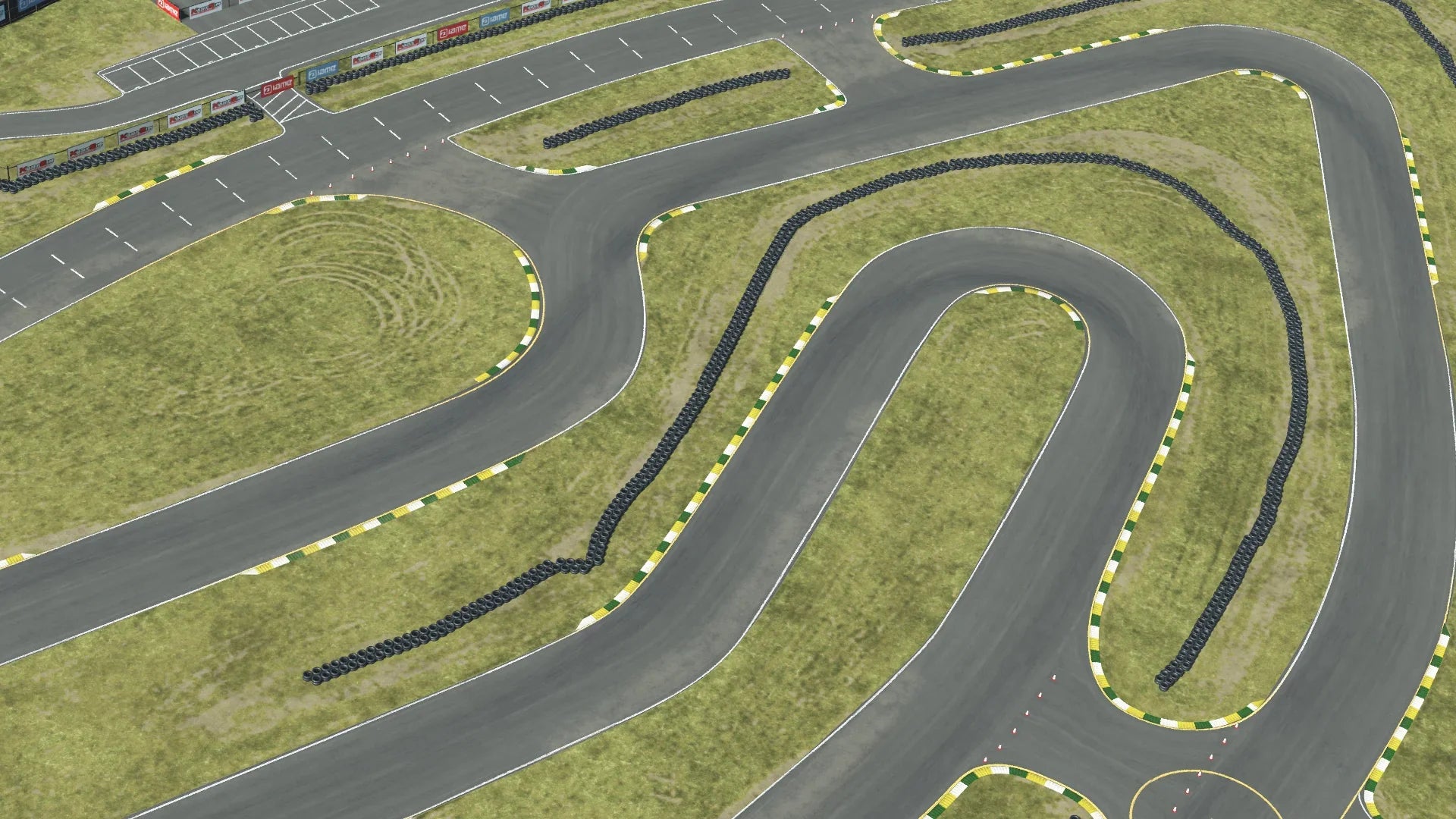 Overhead view of Sonoma karting track technical section – tight turns, tire barriers, and green-yellow curbs on grass