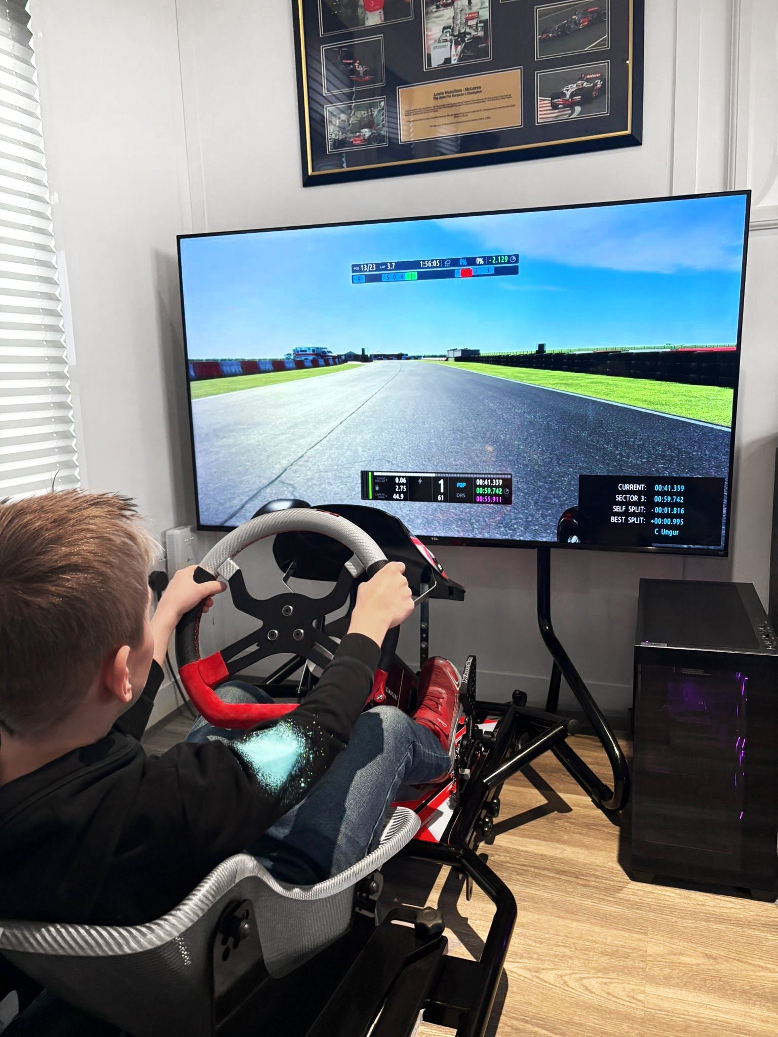 Driver preparing for race weekend using KartSim Pro simulator with laser-scanned track accuracy and telemetry feedback.