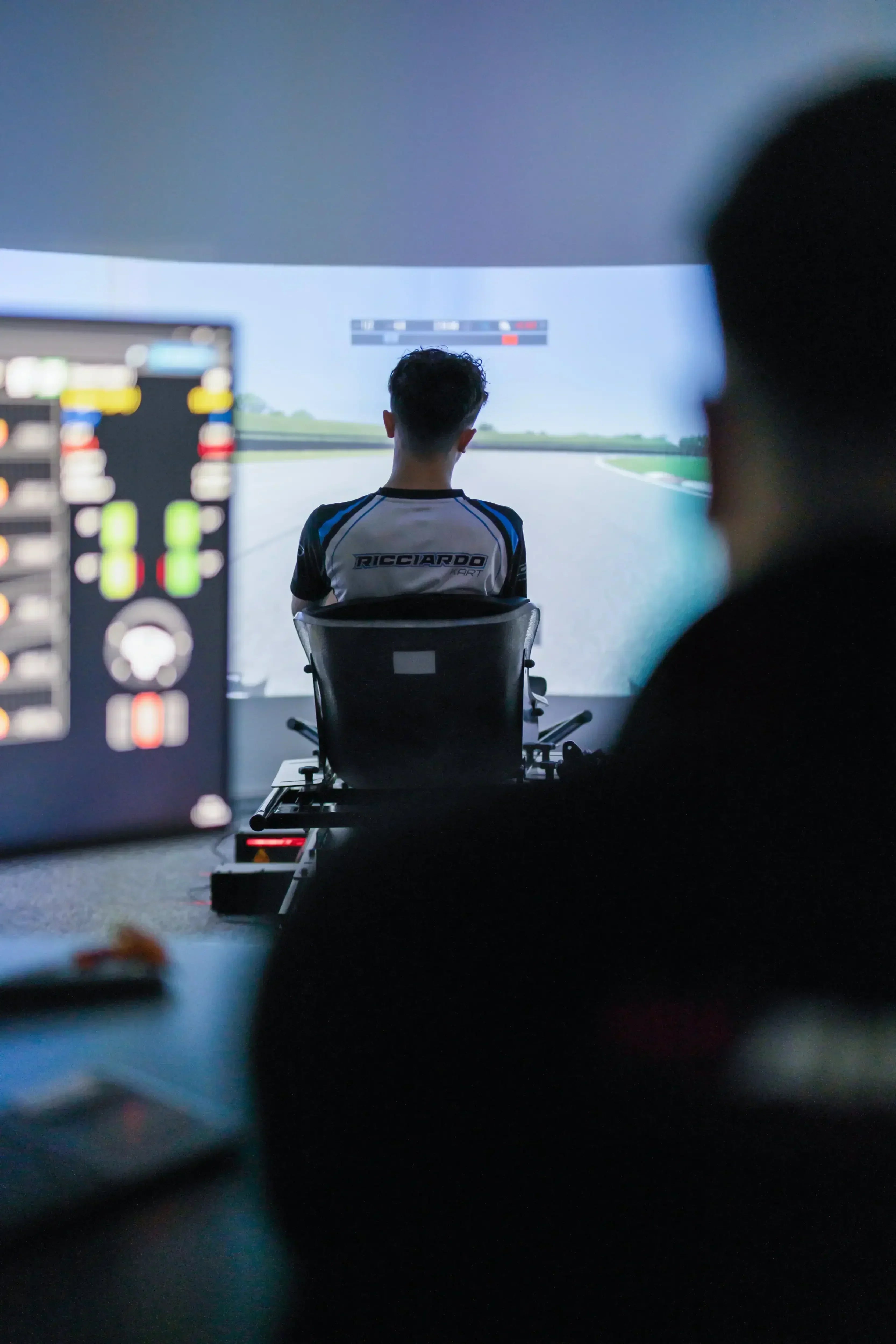 Technical engineer configuring KartSim Pro simulator hardware remotely