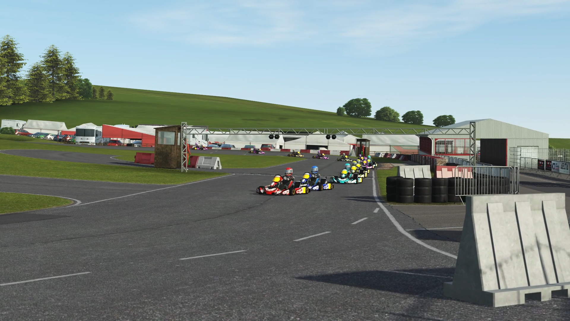 Home karting simulator setup with KartSim software, direct drive wheel, pedals, screen and kart-style driving position.