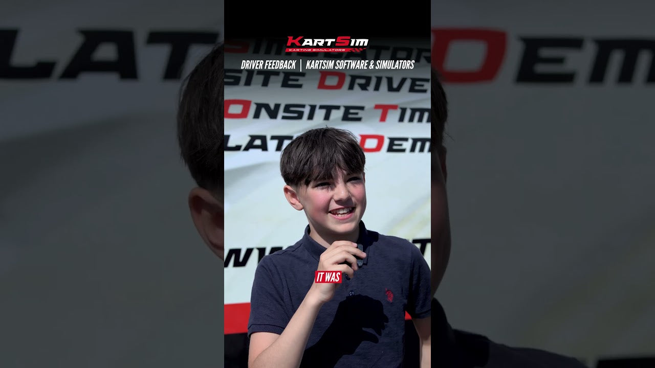Young kart driver giving feedback at KartSim simulator event, smiling with microphone in hand