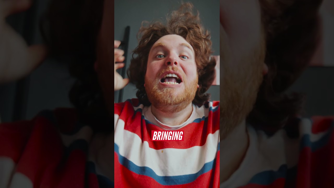 Man in a striped shirt with expressive posture, focus on training environment and driver coaching