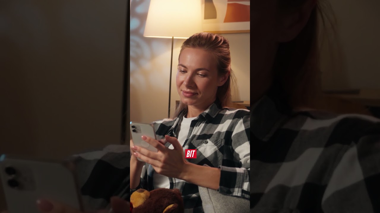 Woman using smartphone in cozy room, not related to kart simulator or racing training.