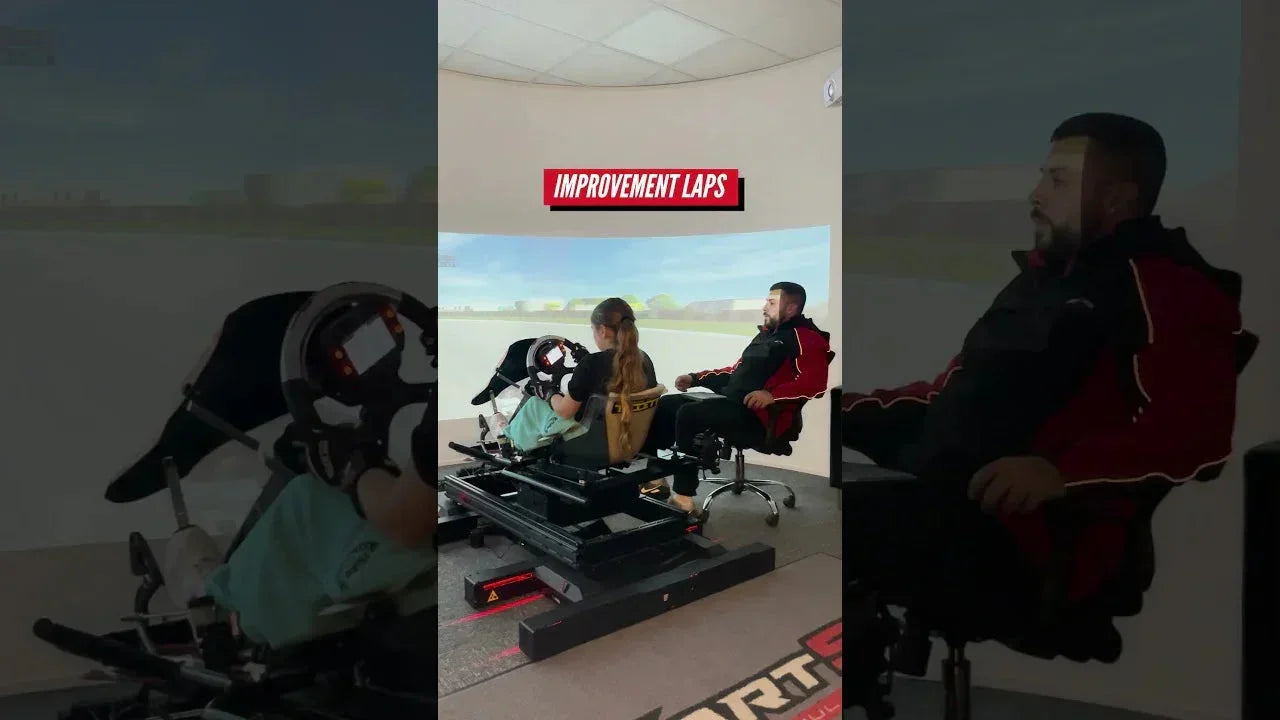 Kart racing simulator with driver in realistic seating position and instructor for kart driver training.