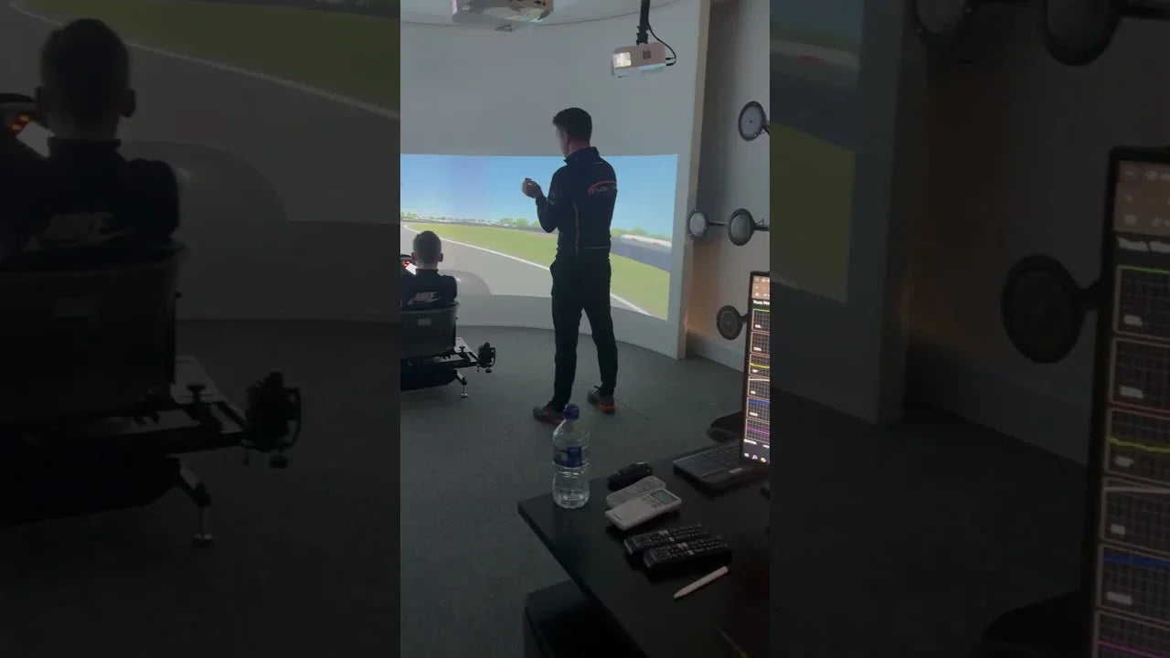 Professional kart racing simulator with telemetry, driver training session, and projected track interface
