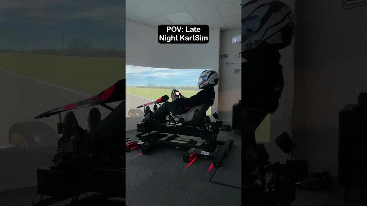 Driver training late at night on a KartSim Pro simulator using realistic kart physics and laser-scanned tracks for professional preparation.