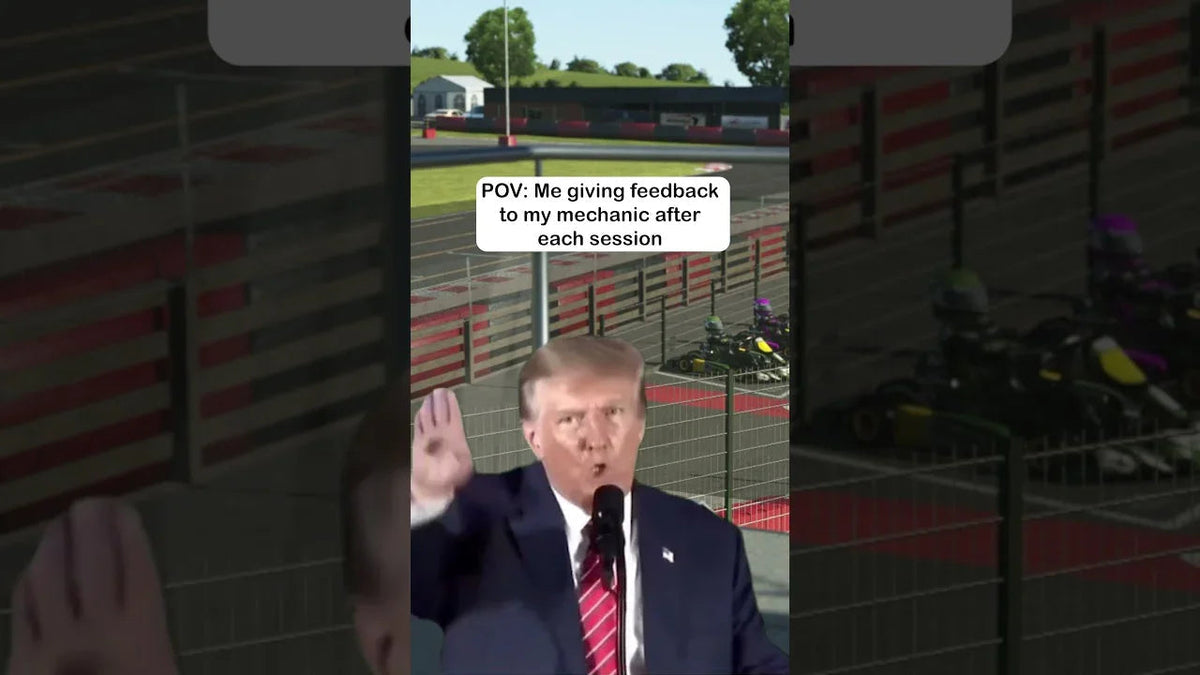 Virtual kart racing simulator track with row of karts, simulating professional kart driver training.