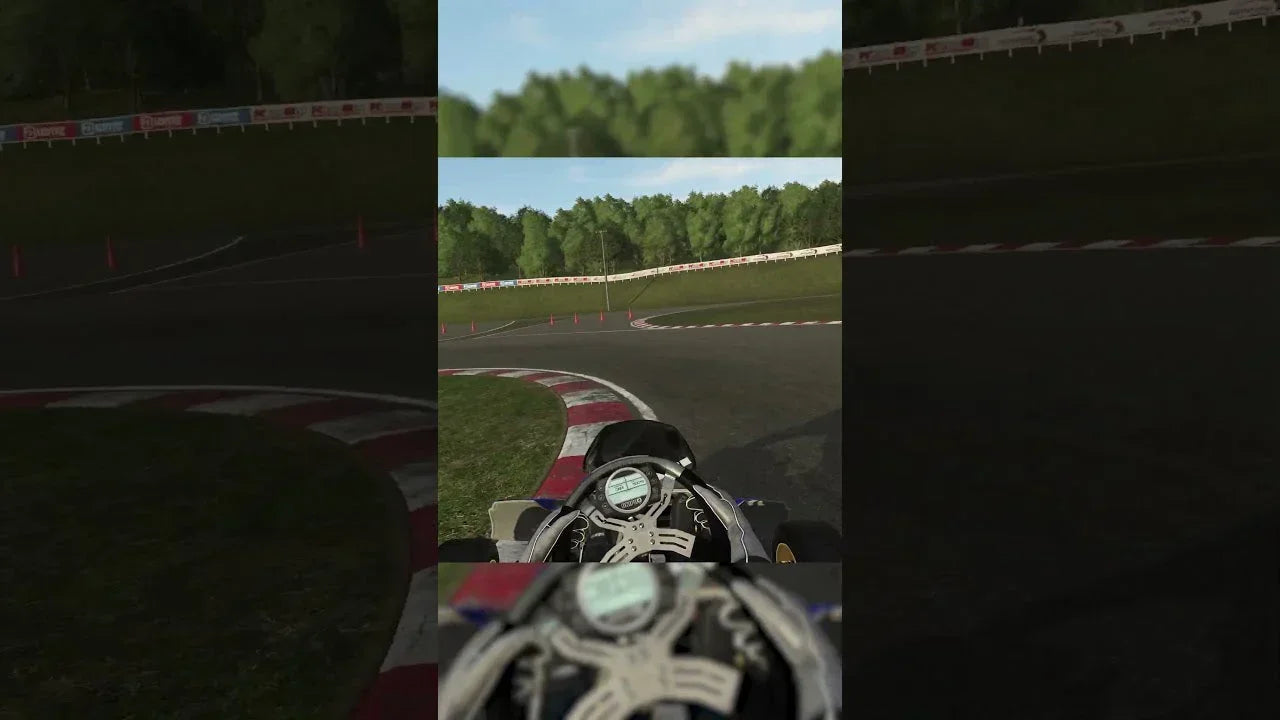 Kart racing simulator cockpit view with steering wheel and telemetry on realistic training track