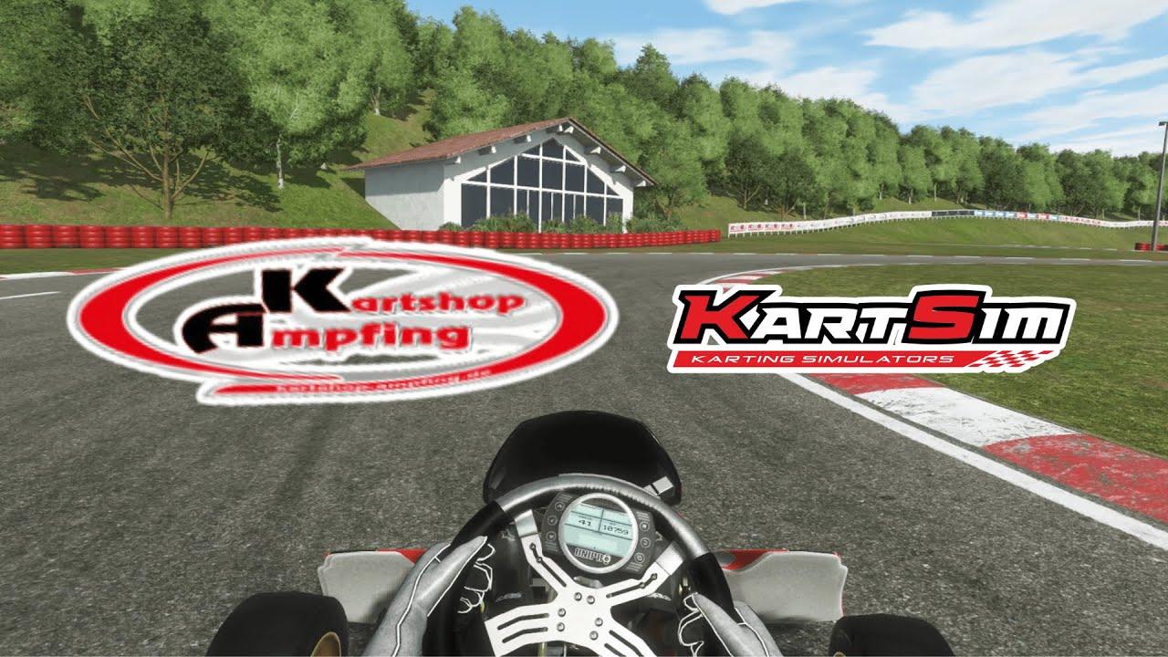 Realistic kart racing simulator cockpit view with steering wheel, digital display, and detailed track environment.