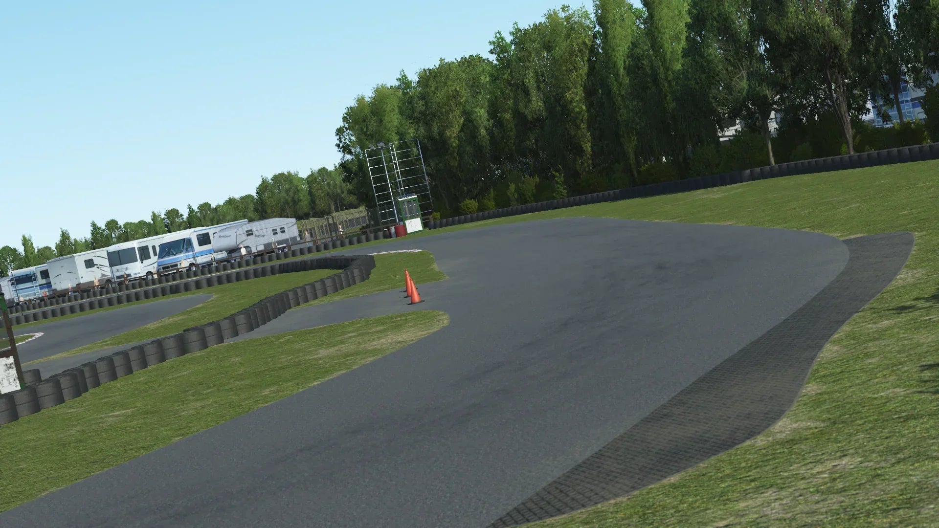 Llandow start-finish straight in KartSim – Immersive KartSim simulation of the Llandow start-finish straight, complete with pit lane entry, marshal posts, and trackside tyre barriers.