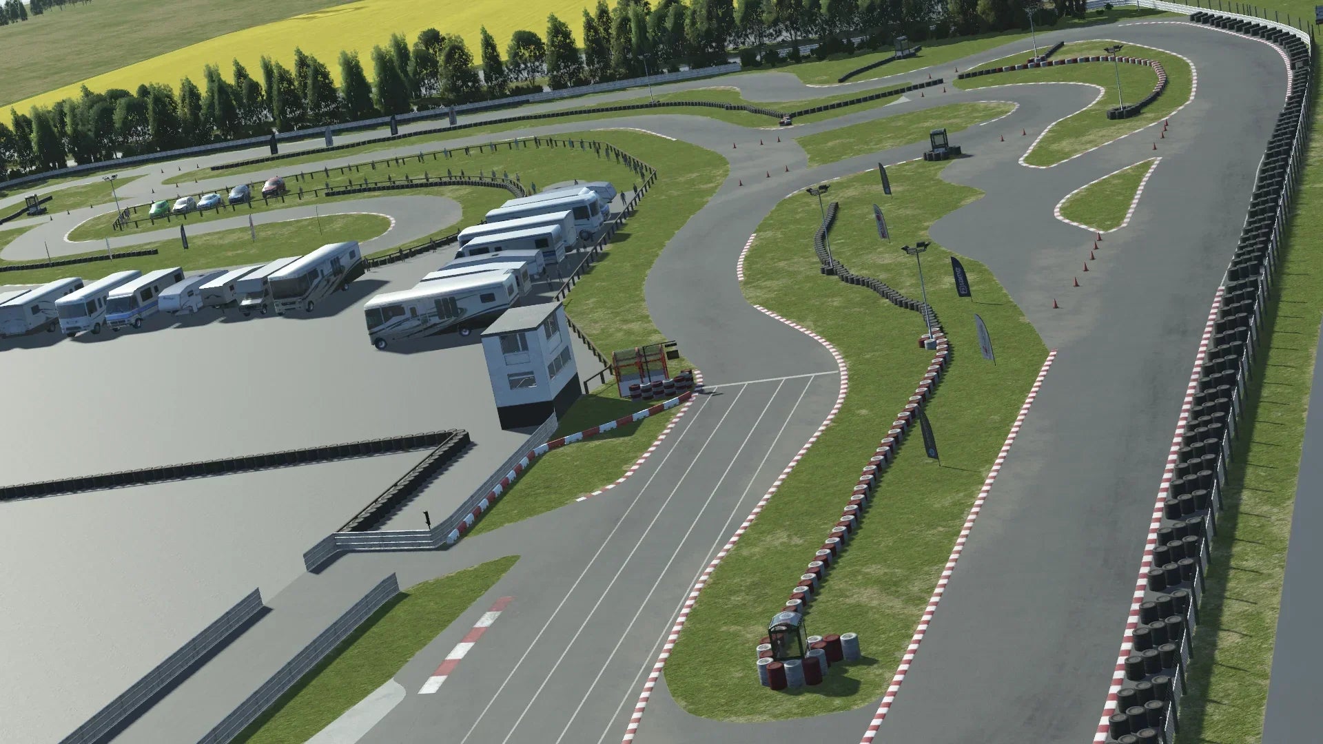 Aerial view of Llandow kart circuit in KartSim – High-resolution simulation of the Llandow Kart Circuit in KartSim, showcasing the technical layout, paddock area, and flowing track design under bright, clear skies.