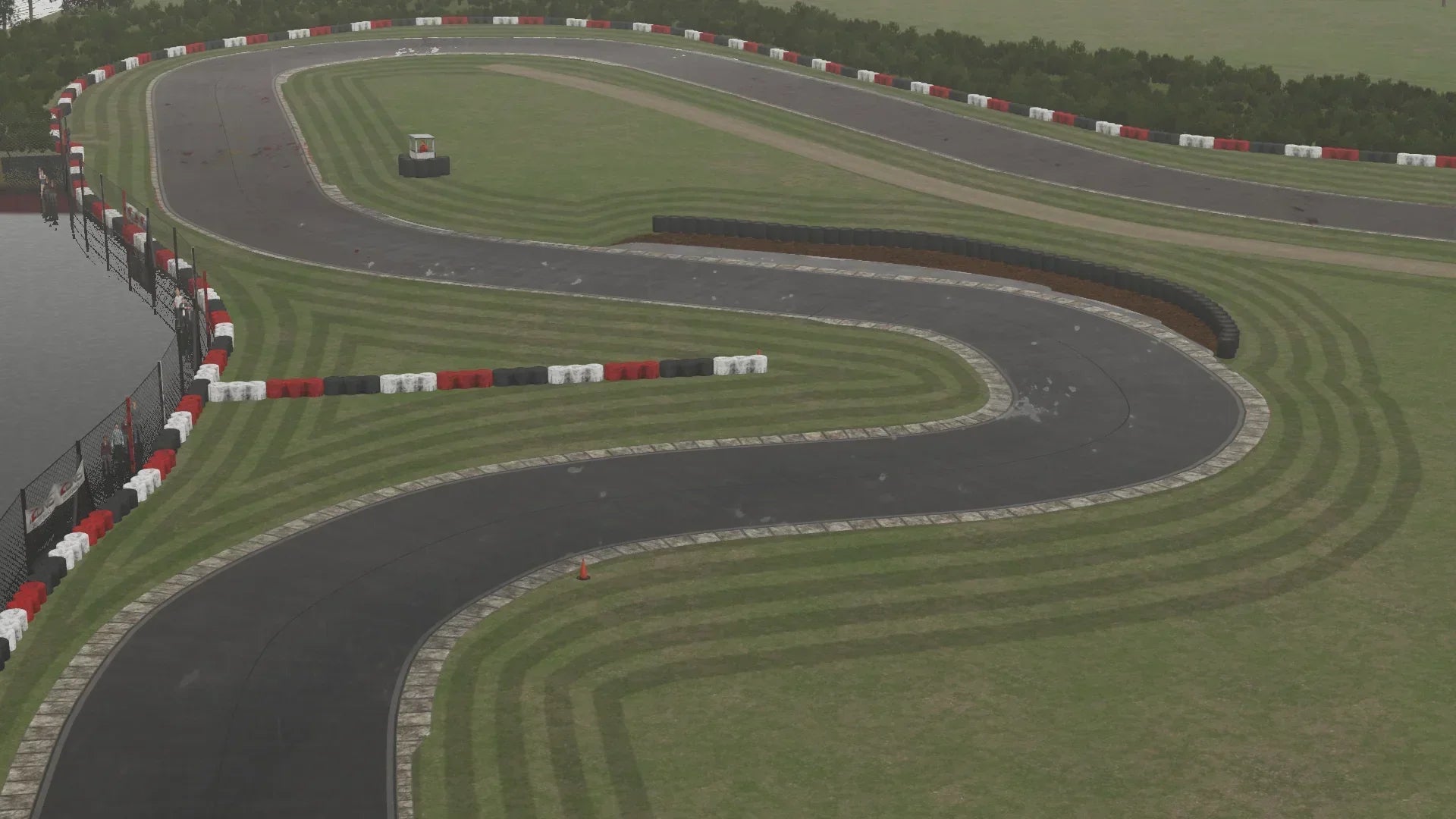 Simulation of wet weather racing at Lydd circuit, featuring realistic reflections, tyre marks, and water buildup.