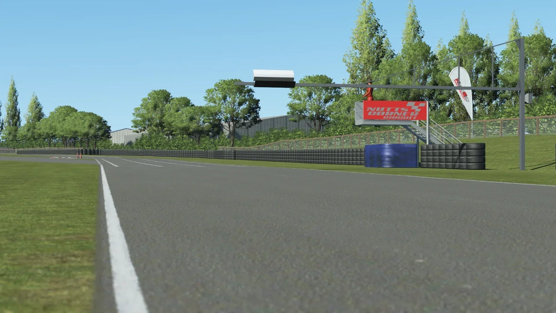 KartSim Nutts Corner Start/Finish Straight – Low-angle trackside shot of the KartSim Nutts Corner start/finish line with timing gantry and sponsor branding.