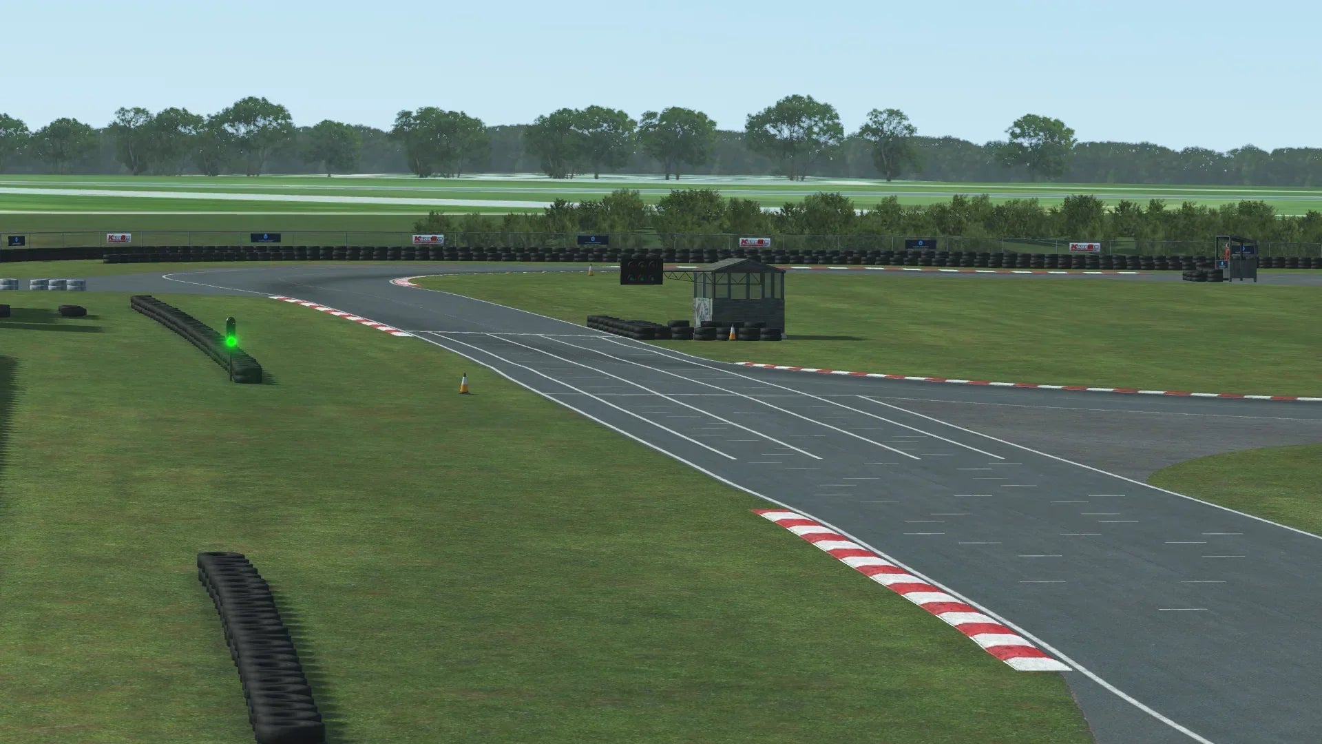 Close-up of KartSim’s Rissington UK circuit in wet weather, showcasing detailed rain effects and realistic puddles on the racing line.