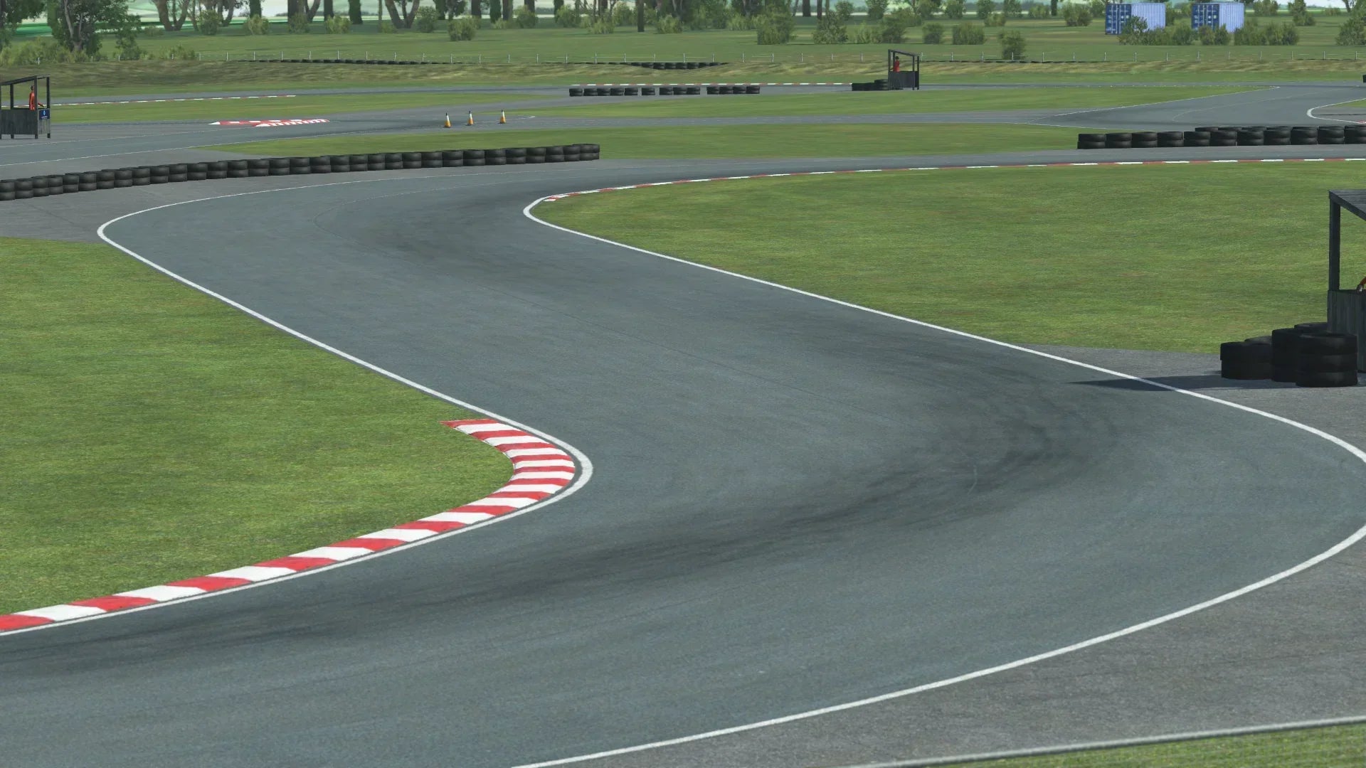 Onboard trackside view of KartSim’s Rissington circuit, highlighting corner exit lines, lush green surroundings and realistic textures.