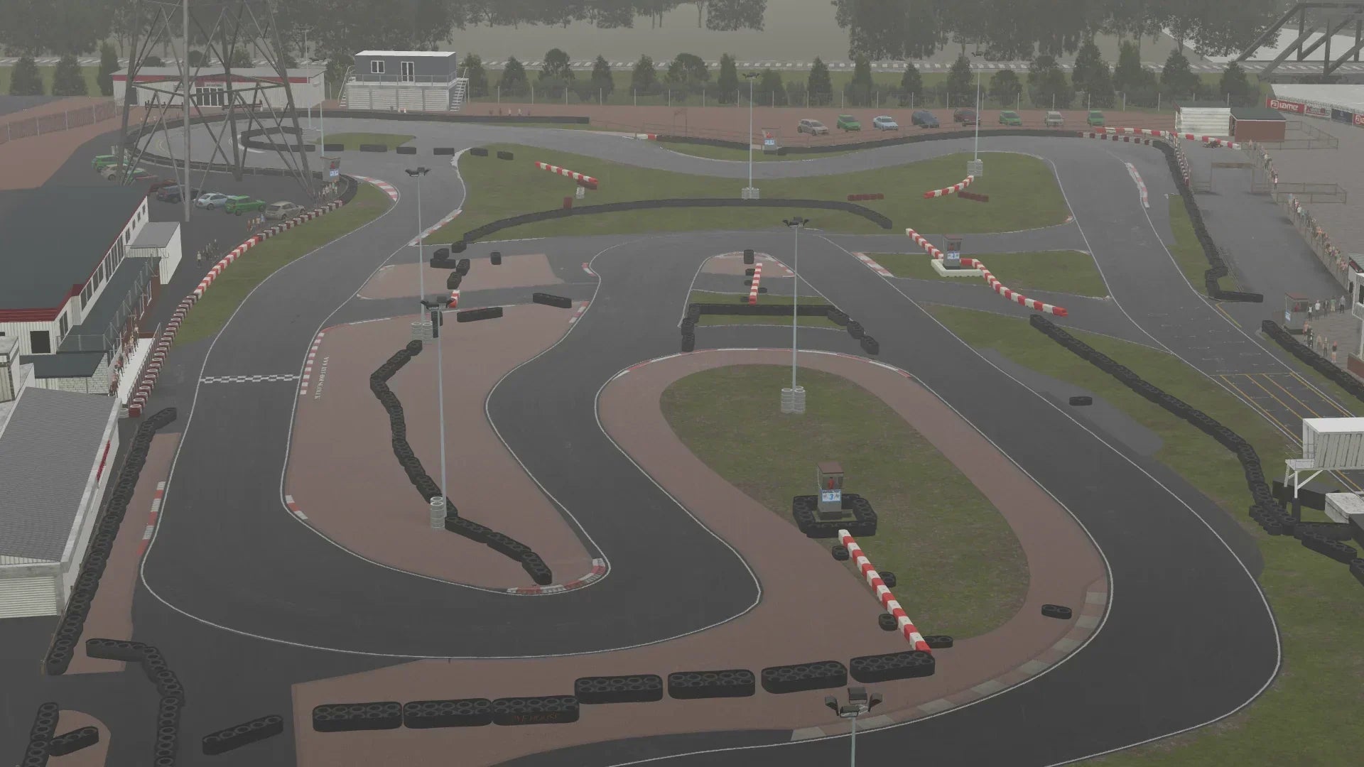 A complete aerial view of the KartSim Rye House kart circuit layout, showing complex chicanes, straights, and pit lane during cloudy conditions.