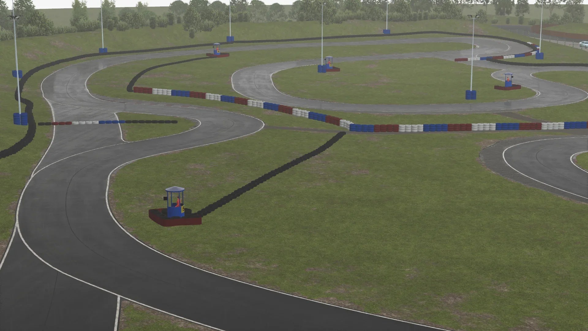 Full overview of the Warden Law kart circuit layout in simulation, showing the full track surrounded by marshall posts and tyre barriers.
