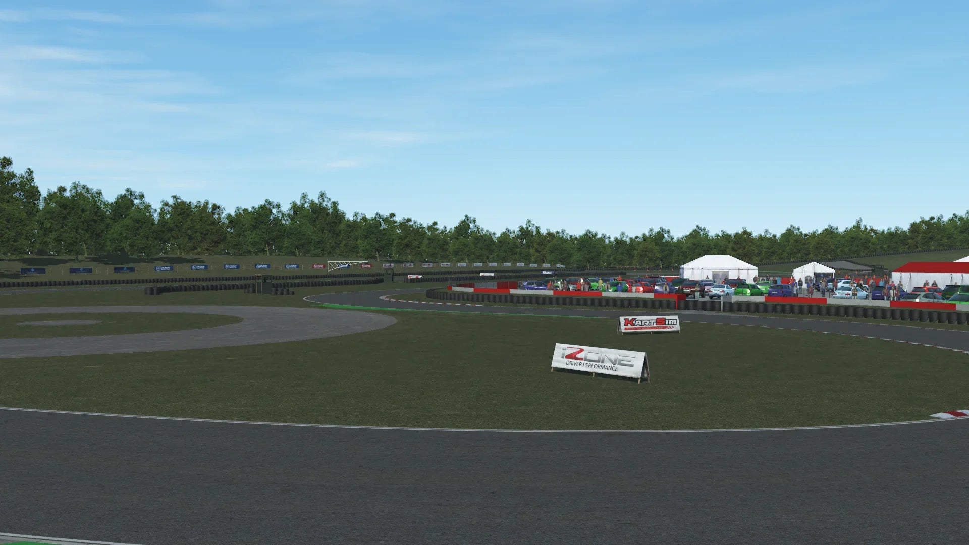 Panoramic shot of the paddock area and track – Showcasing colourful team tents, parked vehicles, and the vibrant race-day atmosphere in the background.