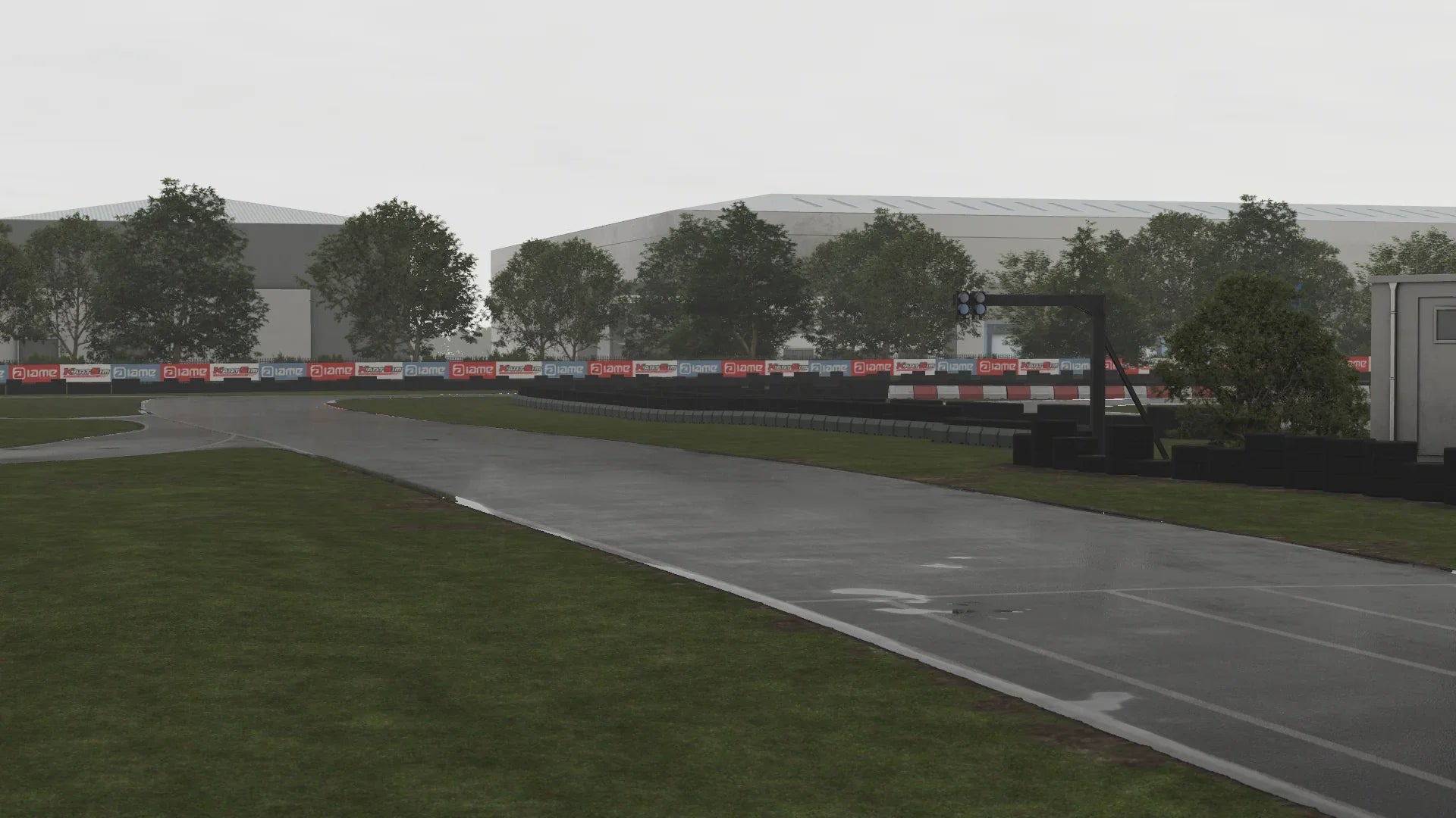 Main straight at Hooton Park in KartSim during rain – Wet asphalt reflecting the red-and-white barrier boards, with the timing gantry and pit buildings visible in the distance.