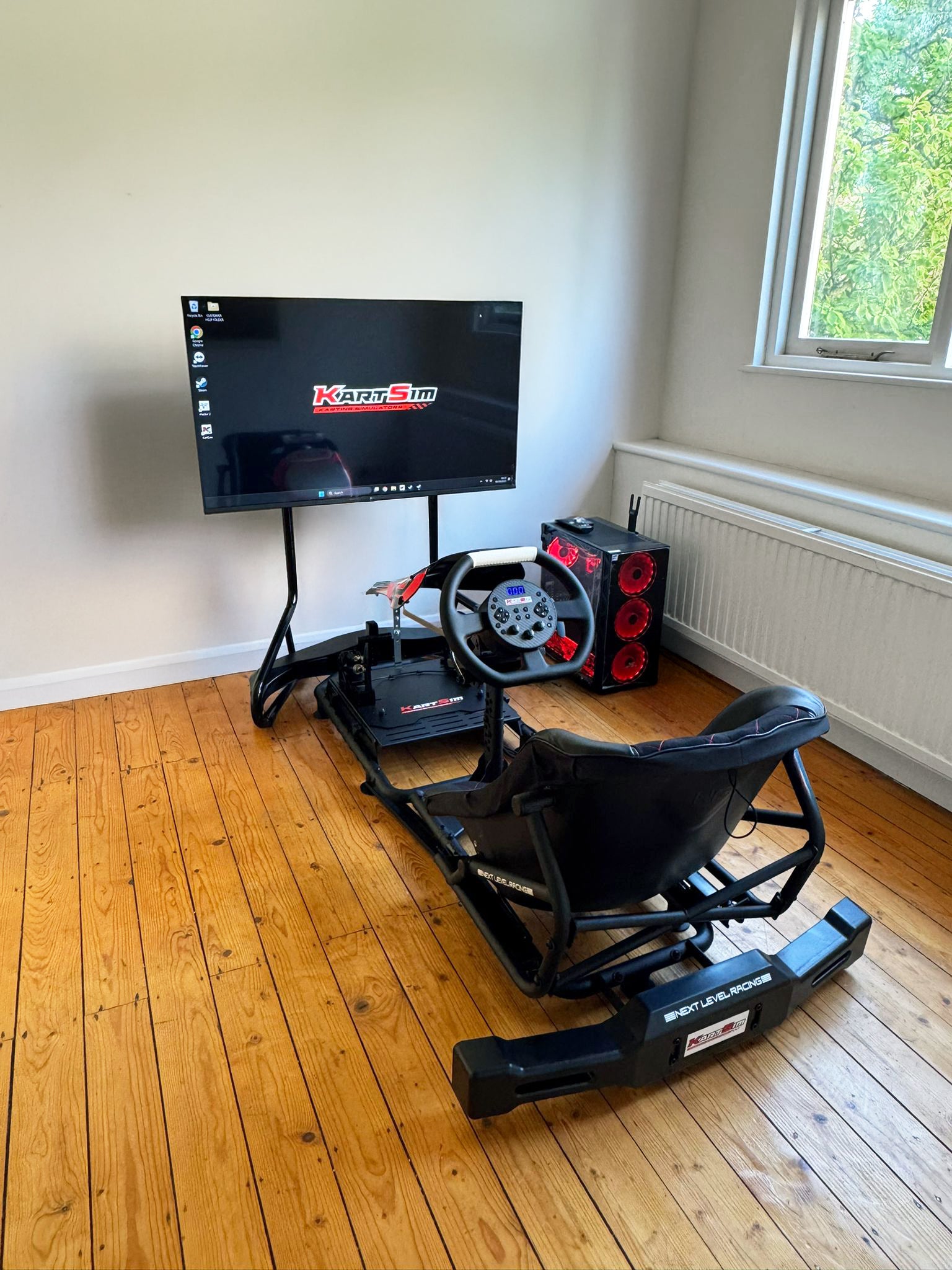 KartSim Esports Simulator delivery – complete home installation with racing seat, direct drive steering wheel, pedals, display, and KartSim Pro Gaming PC for online kart racing