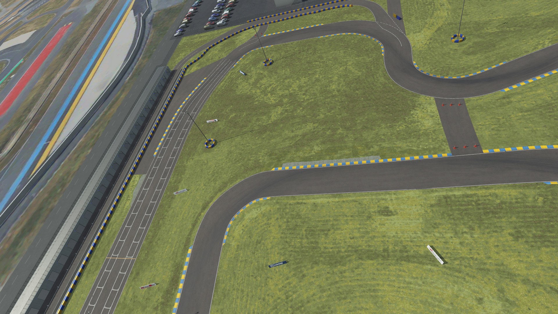 KartSim software render of a Le Mans–style track section, showing the pit lane on the left, winding asphalt race line with blue-and-yellow curbs, and grassy infield areas under a cloudy sky.