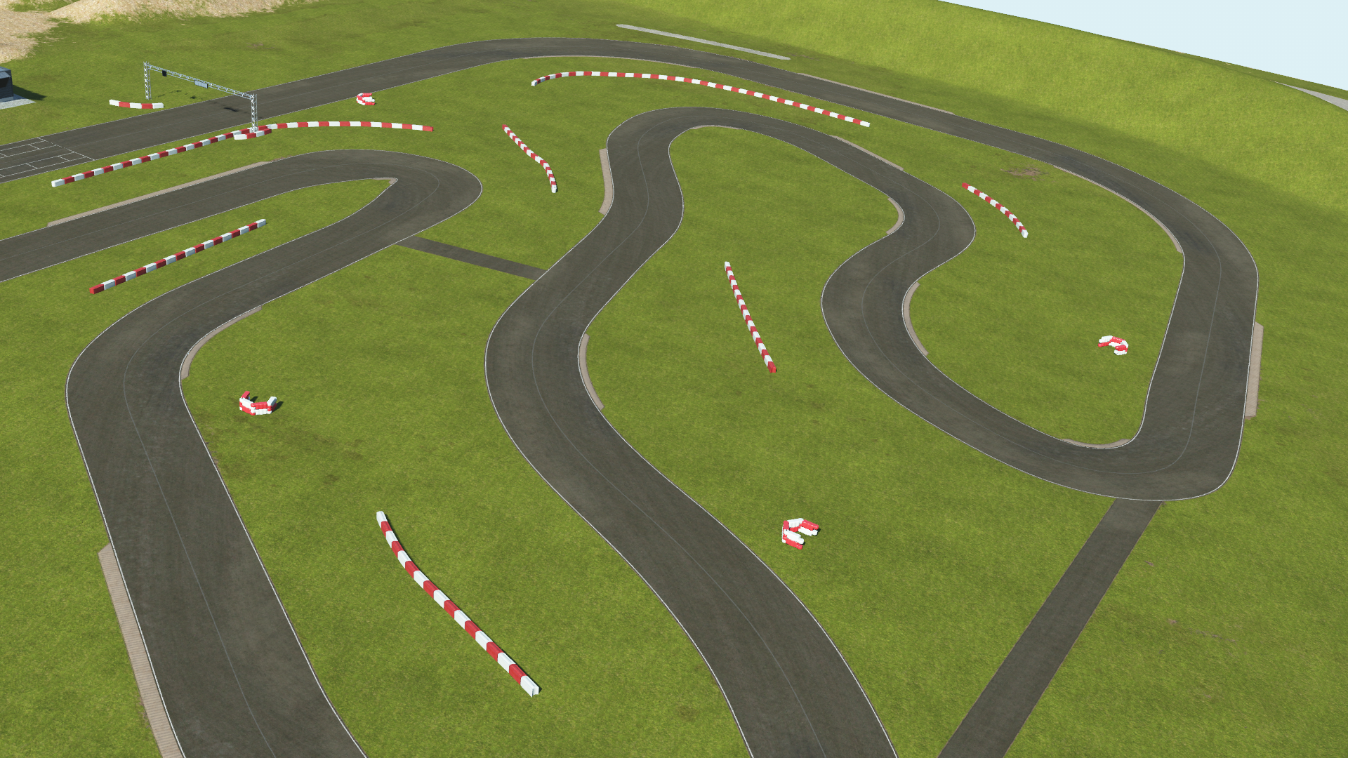 KartSim software overhead rendering of the Rodby kart circuit, showing a series of tight, winding asphalt chicanes on a green grass field with red-and-white barrier segments lining the track and a start/finish gantry visible in the upper left under a clear sky.