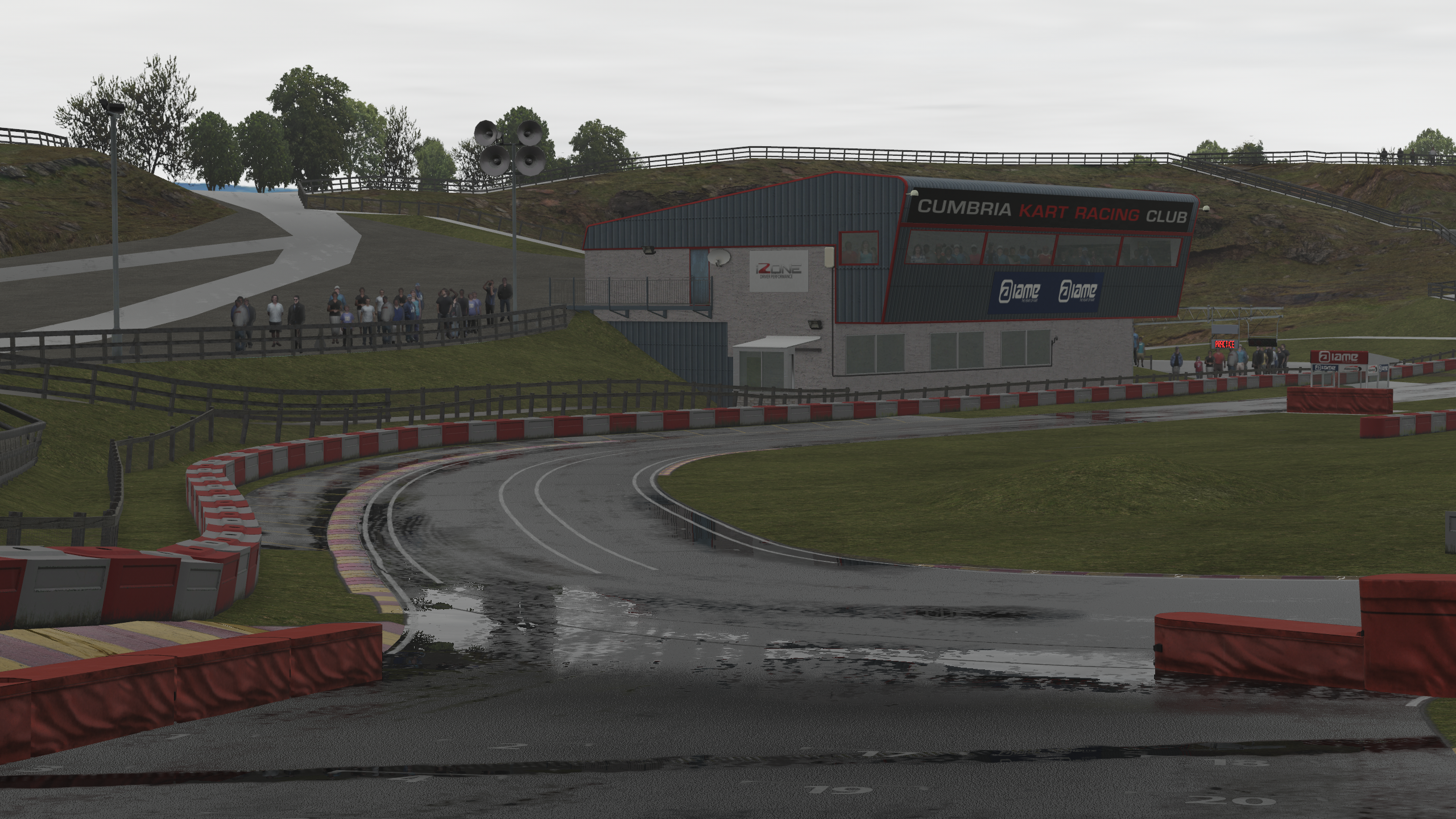 Rain-soaked corner at Rowrah rendered in KartSim Pro UK, capturing wet-weather racing conditions.