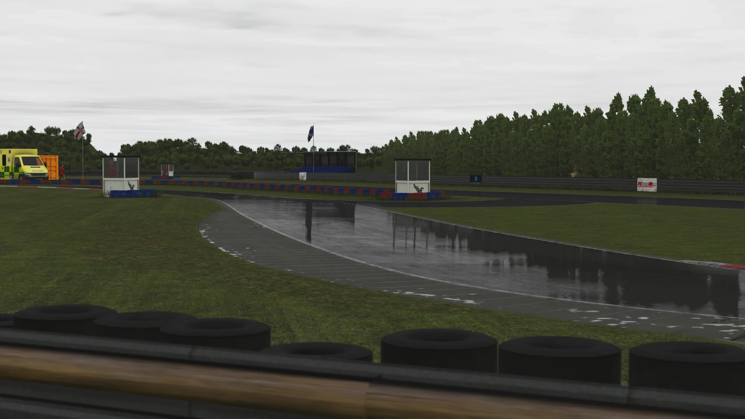 Wet racing line reflecting on the tarmac at Clay Pigeon in KartSim simulation.