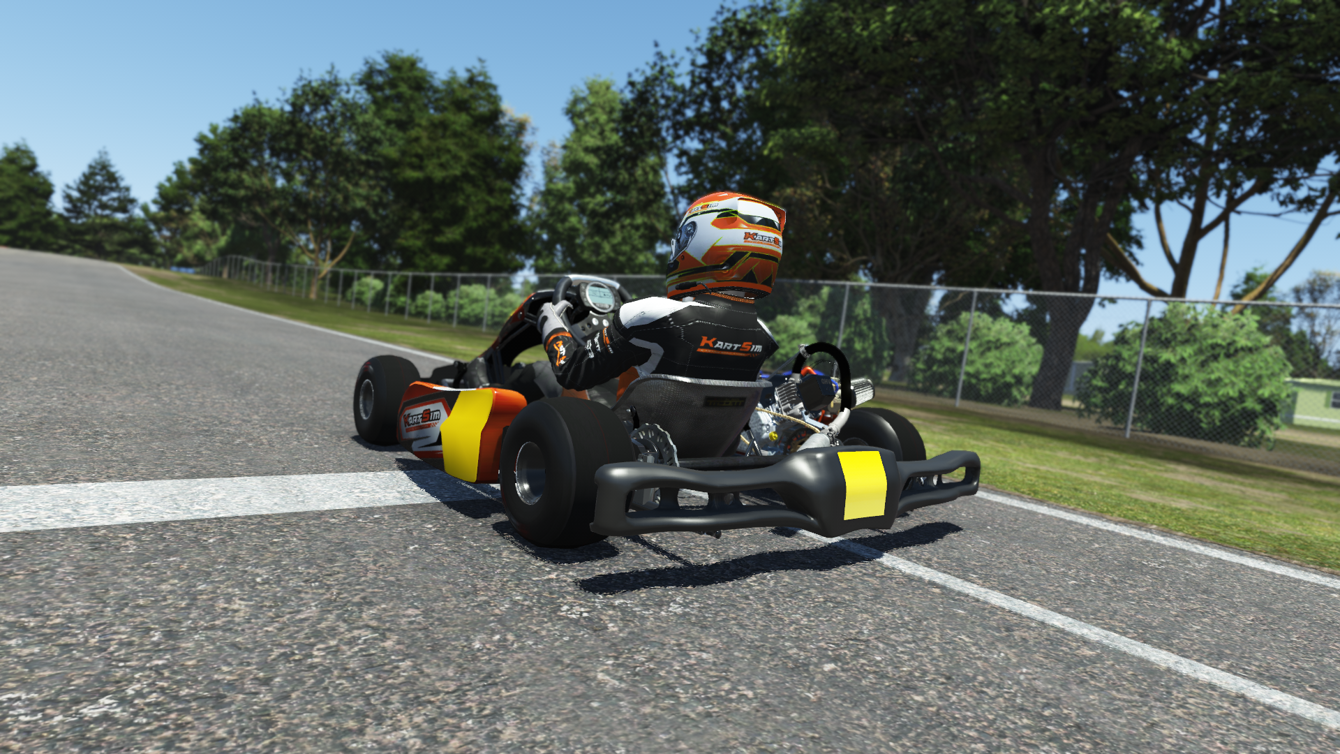 Briggs 206 Cadet 000 kart with blue and white livery shown on KartSim software racing on kart track with tire barriers