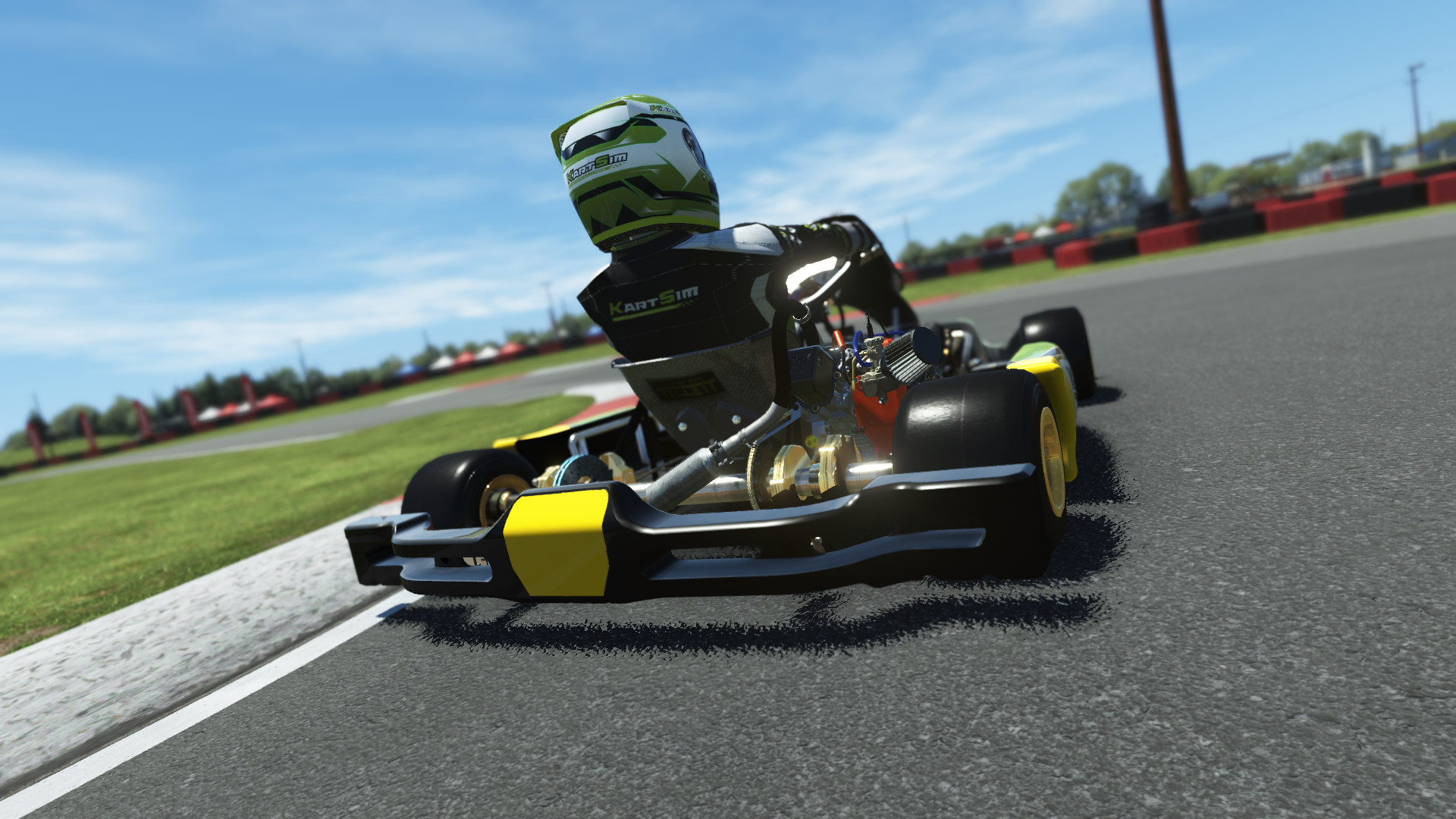 Briggs 206 Junior 005 kart with red, white, and black livery shown on KartSim software racing on kart track with tire barriers
