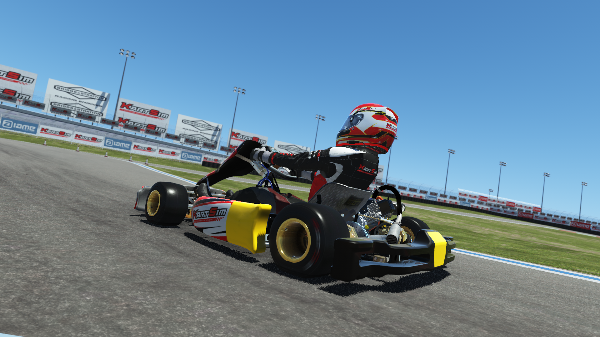 Briggs 206 Senior 004 kart with red and white design shown on KartSim software racing on kart track with tire barriers