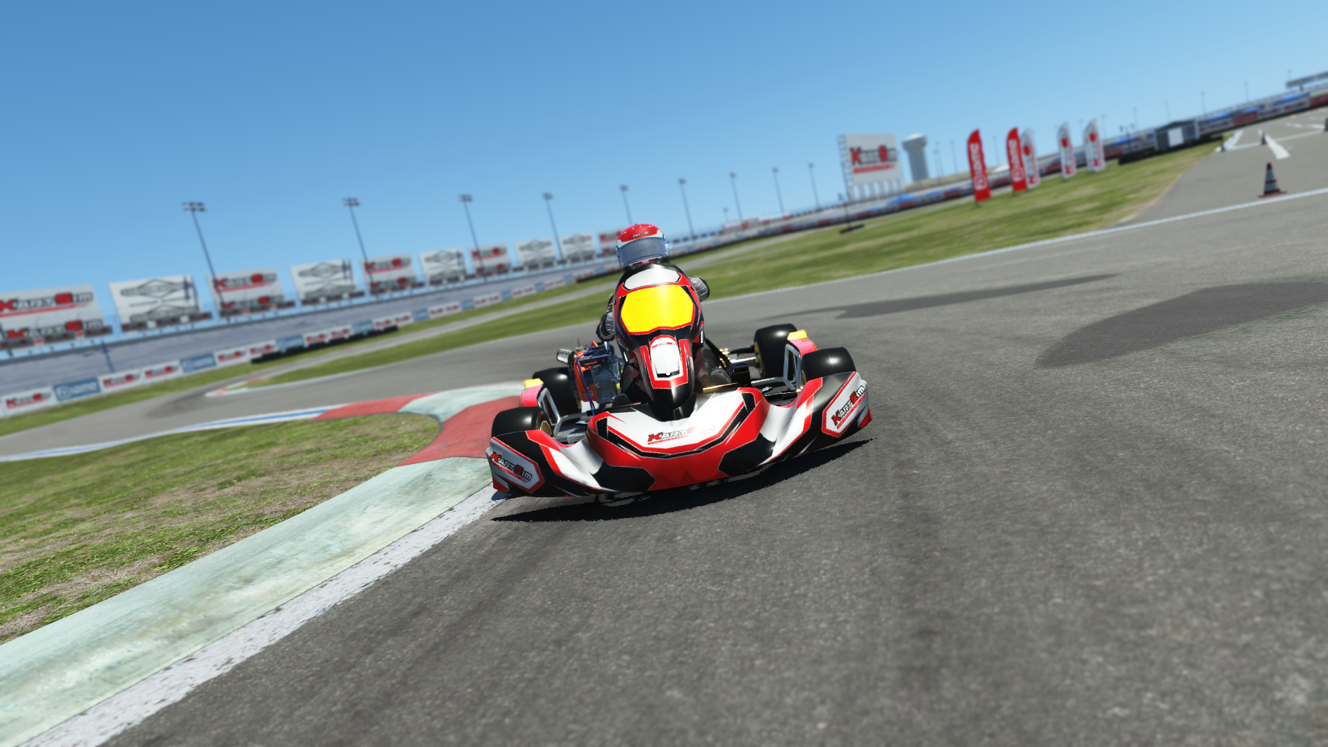 Briggs 206 Senior 006 kart with red and white design shown on KartSim software racing on kart track with tire barriers
