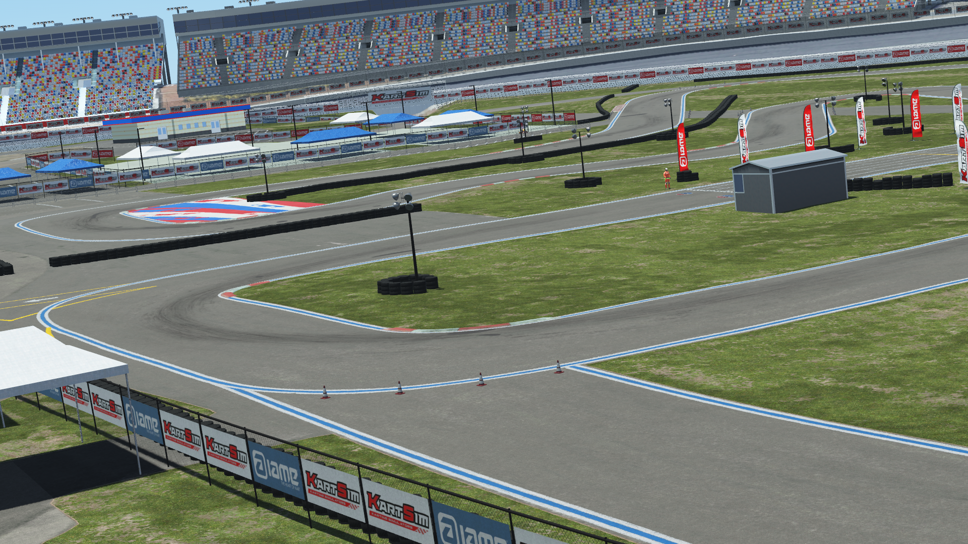 Karting track at a motorsport complex with grandstands, tents, and surrounding barriers