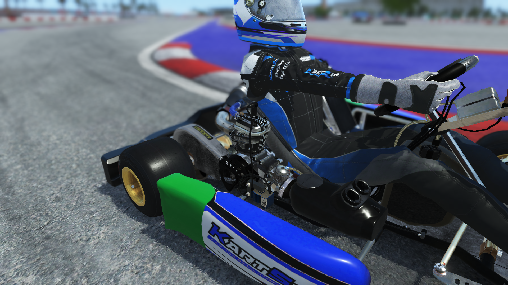 IAME X30 Junior US 005 kart with blue, white, and yellow design shown on KartSim software racing on kart track with tire barriers