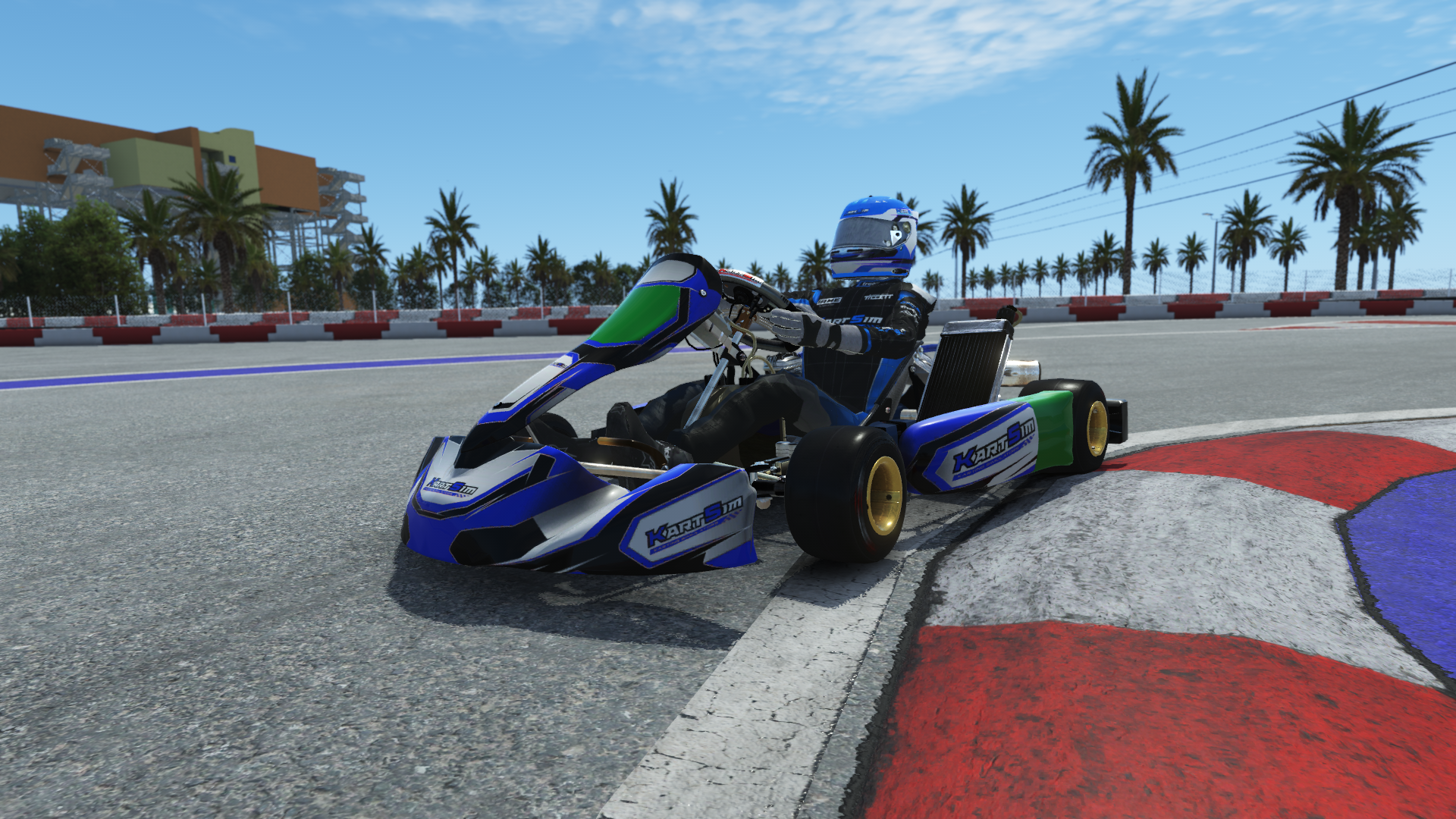 IAME X30 Junior US 008 kart with blue, white, and yellow design on a karting track with tire barriers