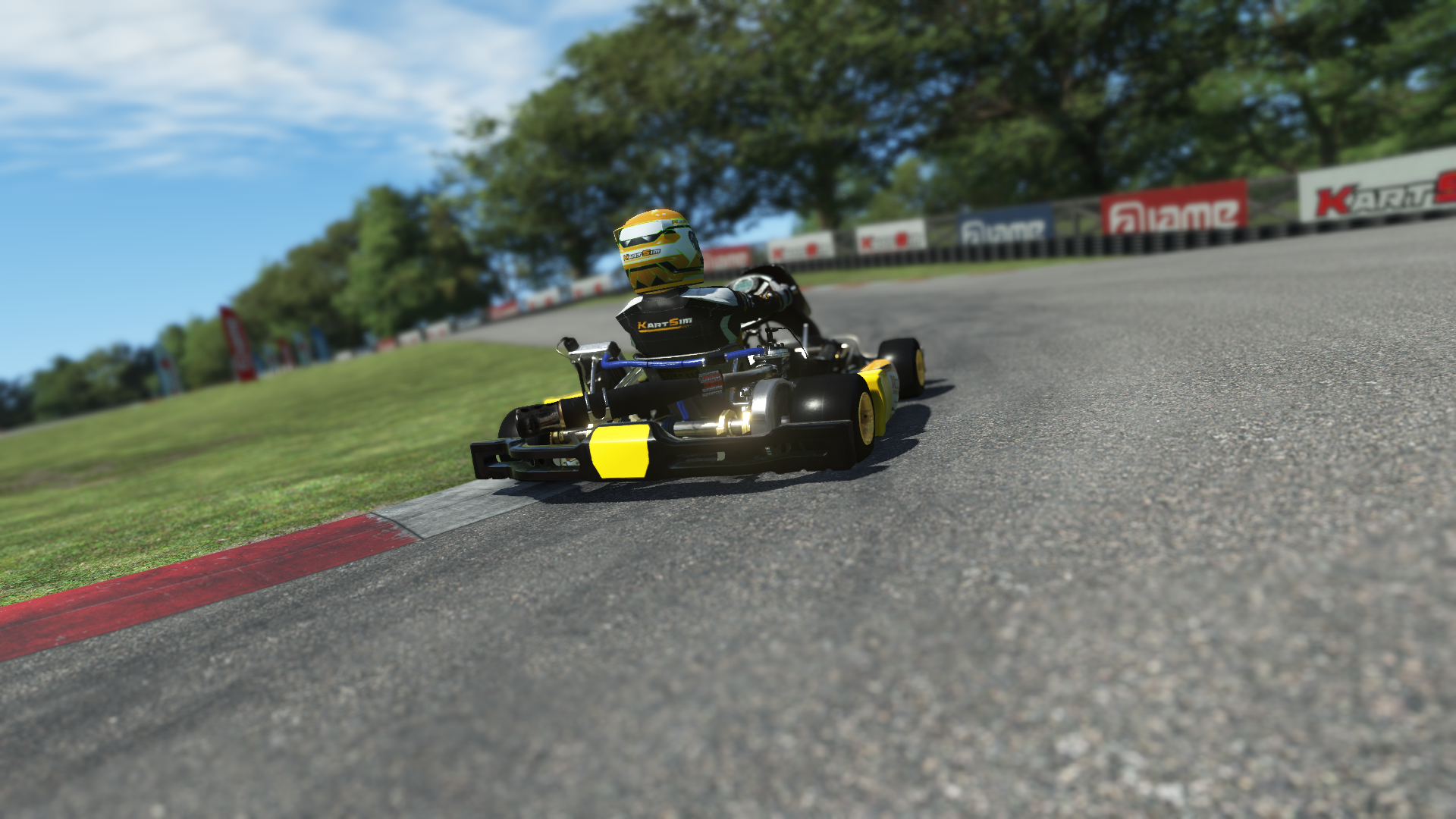 IAME X30 Senior US 000 kart with blue and yellow livery shown on KartSim software racing on kart track with tire barriers