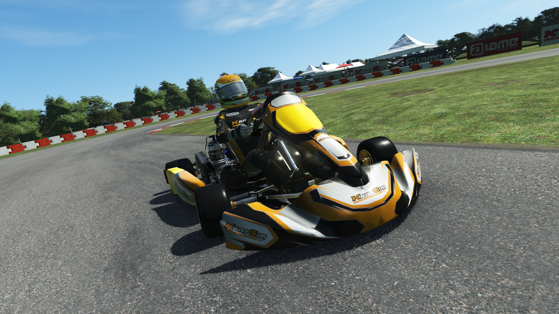 IAME X30 Senior US 002 kart with blue and yellow design shown on KartSim software racing on kart track with tire barriers