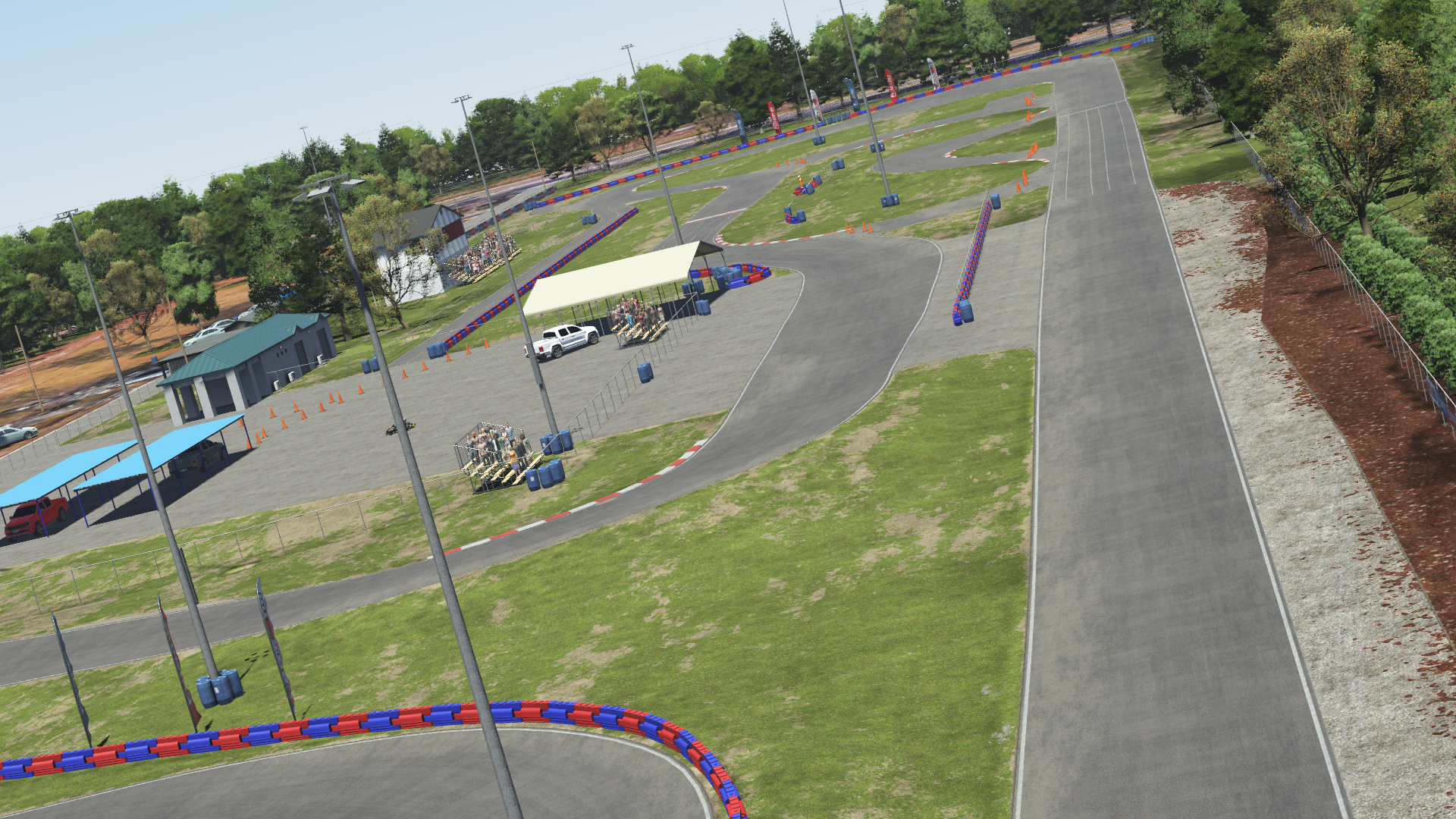 Aerial view of Jacksonville karting circuit – outdoor track with red and blue barriers, pit structures, and service buildings
